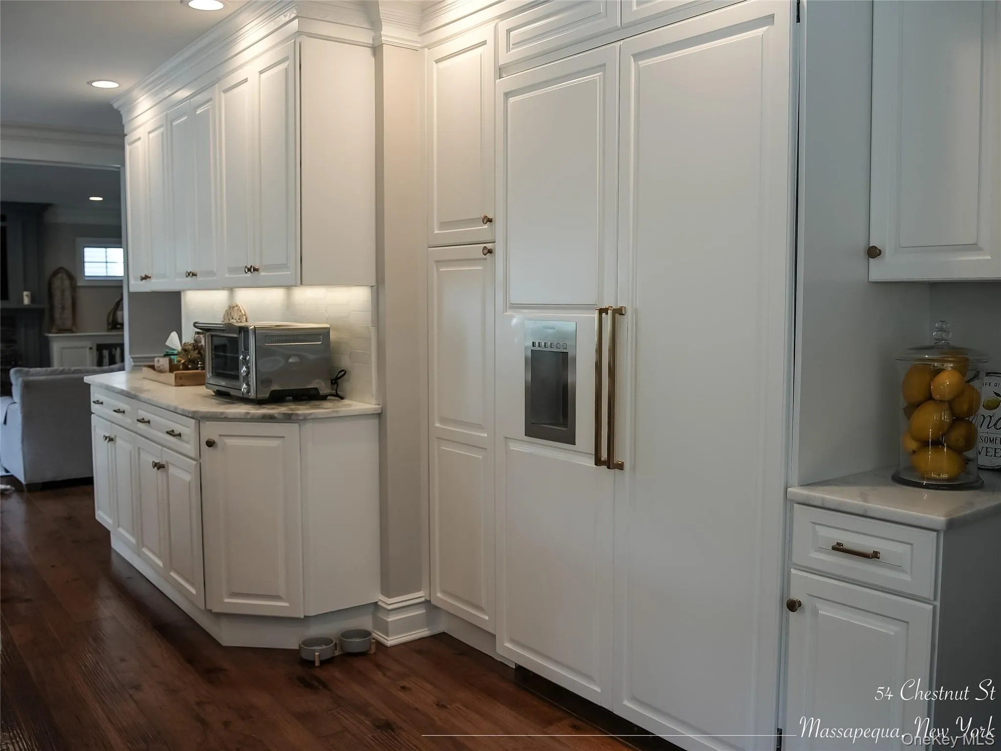 Kitchen with white cabinetry, paneled 48’ Thermador refrigerator. Kitchen with white cabinetry, paneled 48’ Thermador refrigerator.