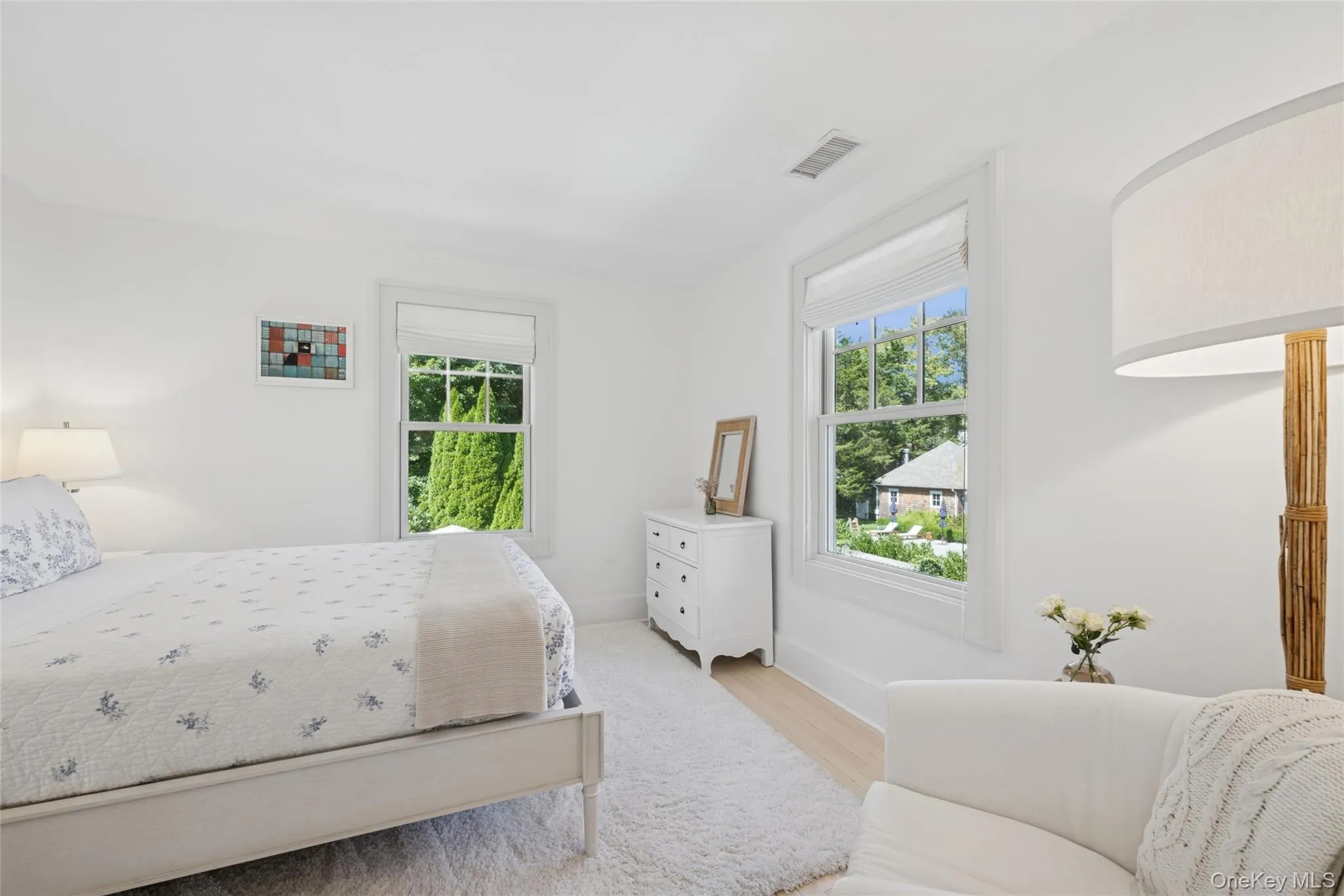 Bedroom featuring wood finished floors and baseboards Bedroom featuring wood finished floors and baseboards
