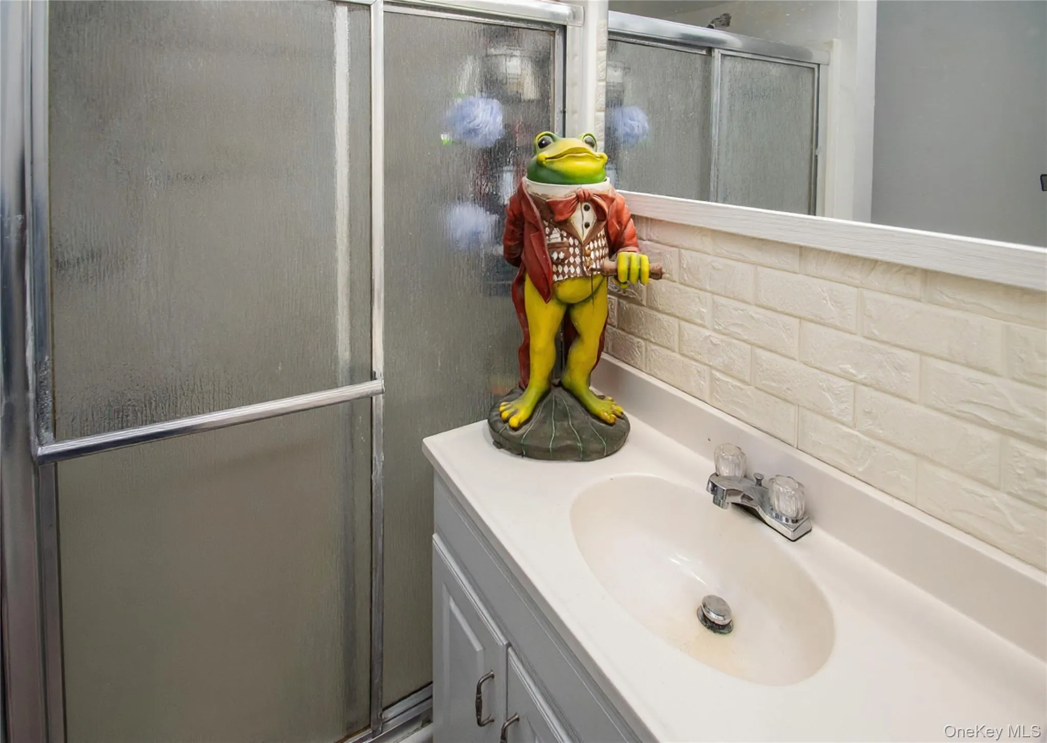 Full bathroom with vanity, a shower stall, and tasteful backsplash Full bathroom with vanity, a shower stall, and tasteful backsplash