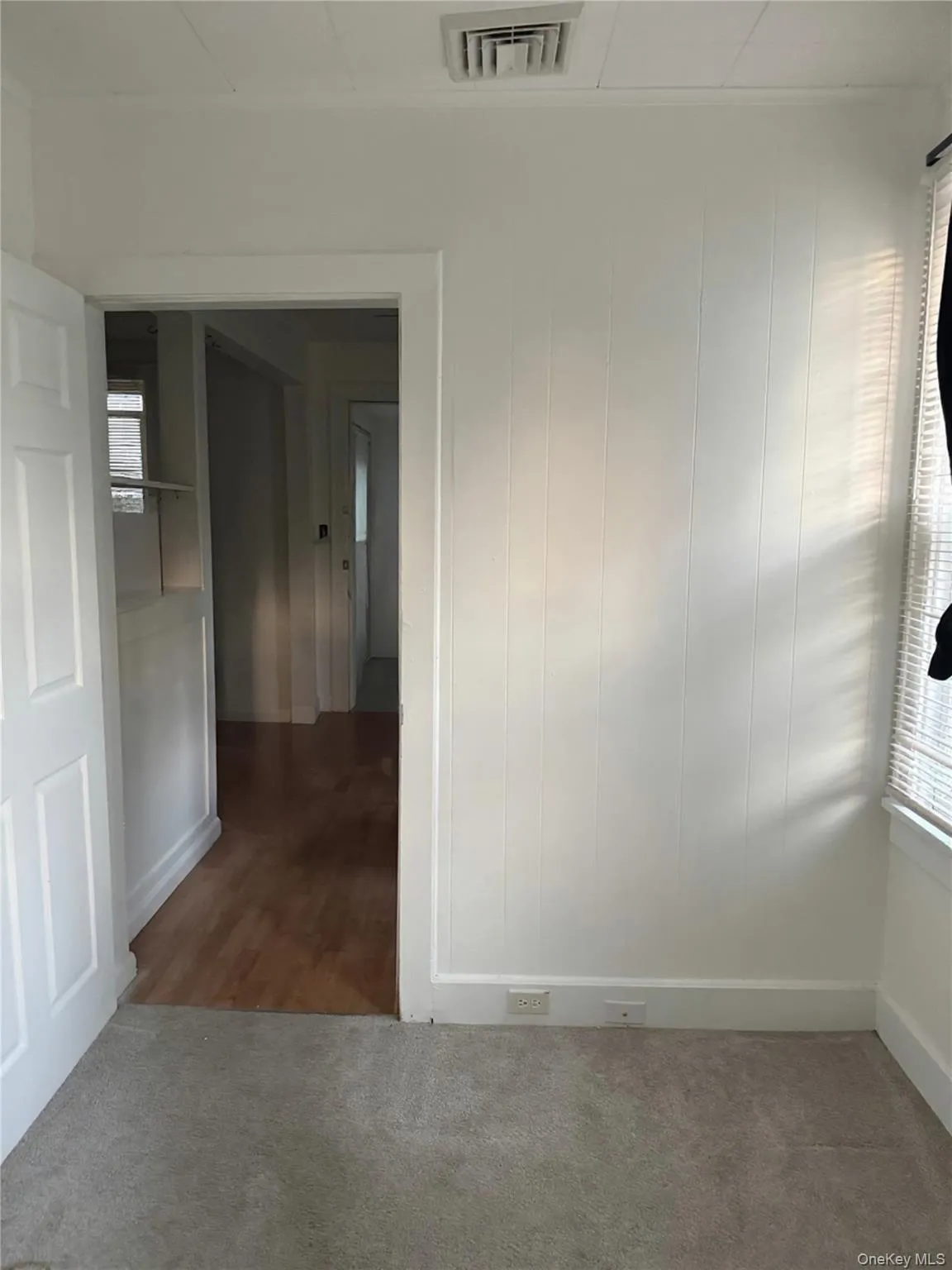 Carpeted spare room featuring baseboards Carpeted spare room featuring baseboards