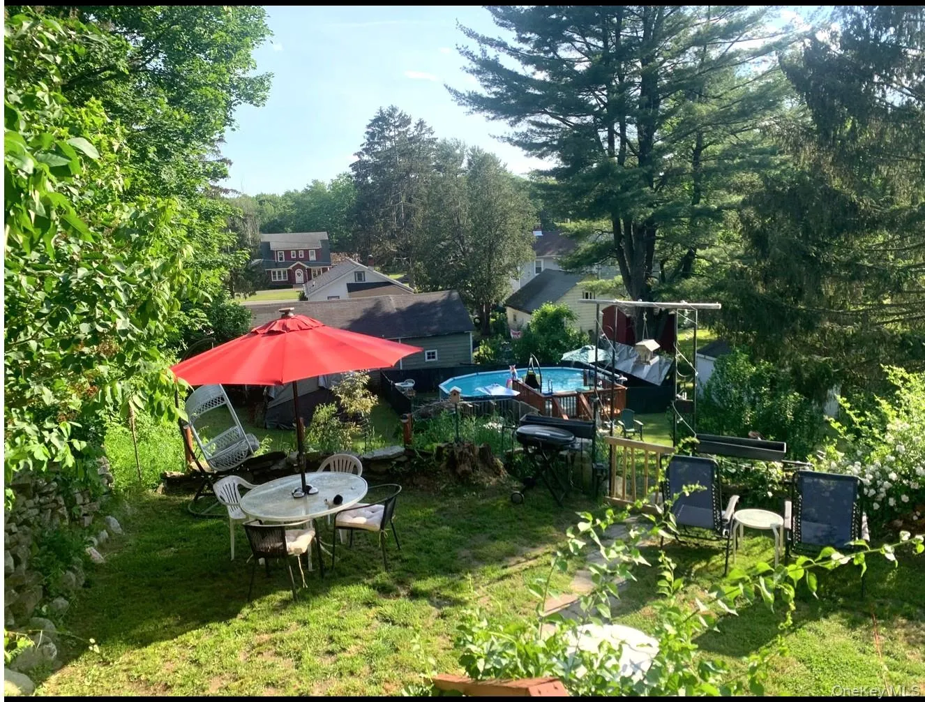 View of green lawn featuring view of scattered trees View of green lawn featuring view of scattered trees