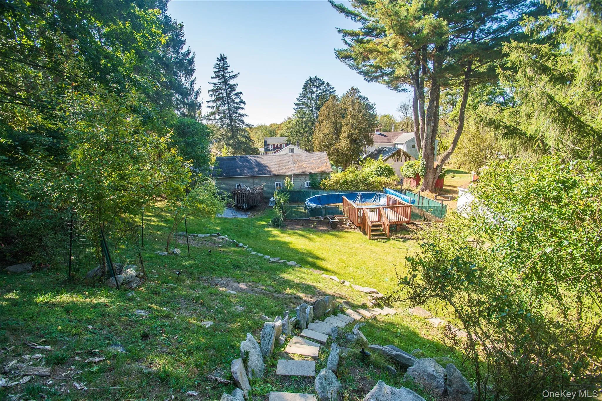 View of grassy yard with a wooden deck View of grassy yard with a wooden deck