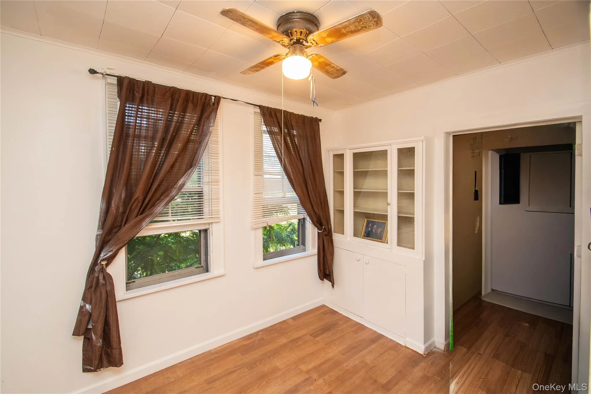 Spare room featuring wood finished floors and a ceiling fan Spare room featuring wood finished floors and a ceiling fan