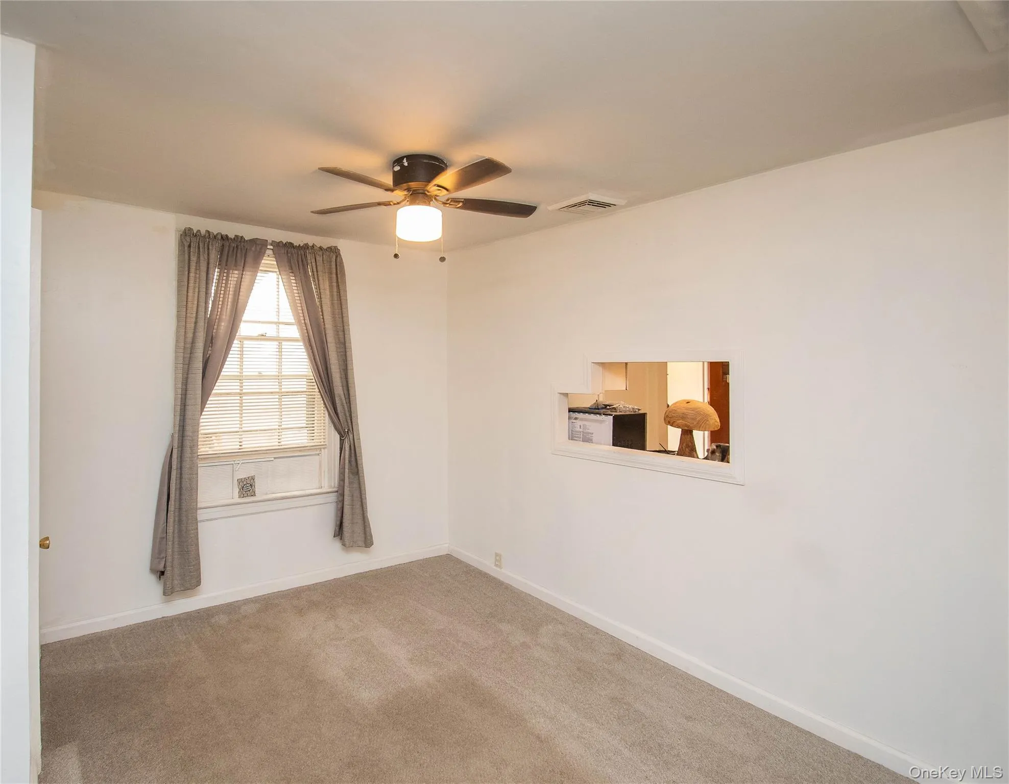 Empty room featuring carpet flooring and a ceiling fan Empty room featuring carpet flooring and a ceiling fan