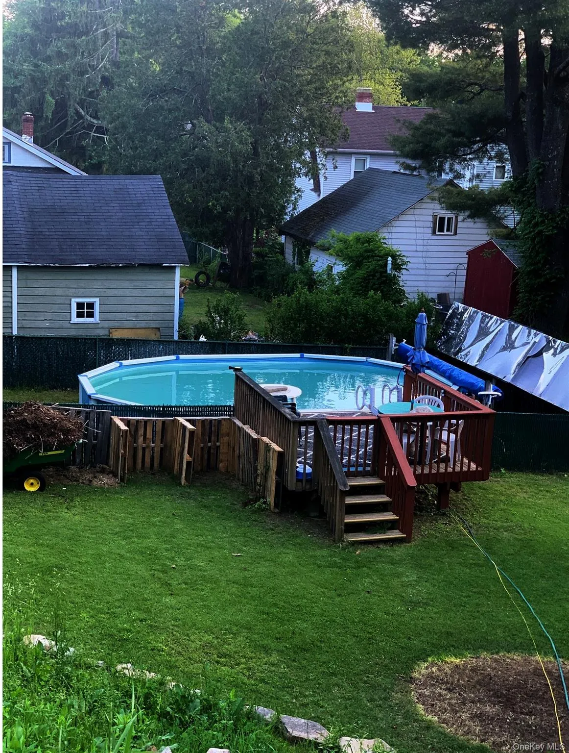 Outdoor pool with a lawn and a deck Outdoor pool with a lawn and a deck