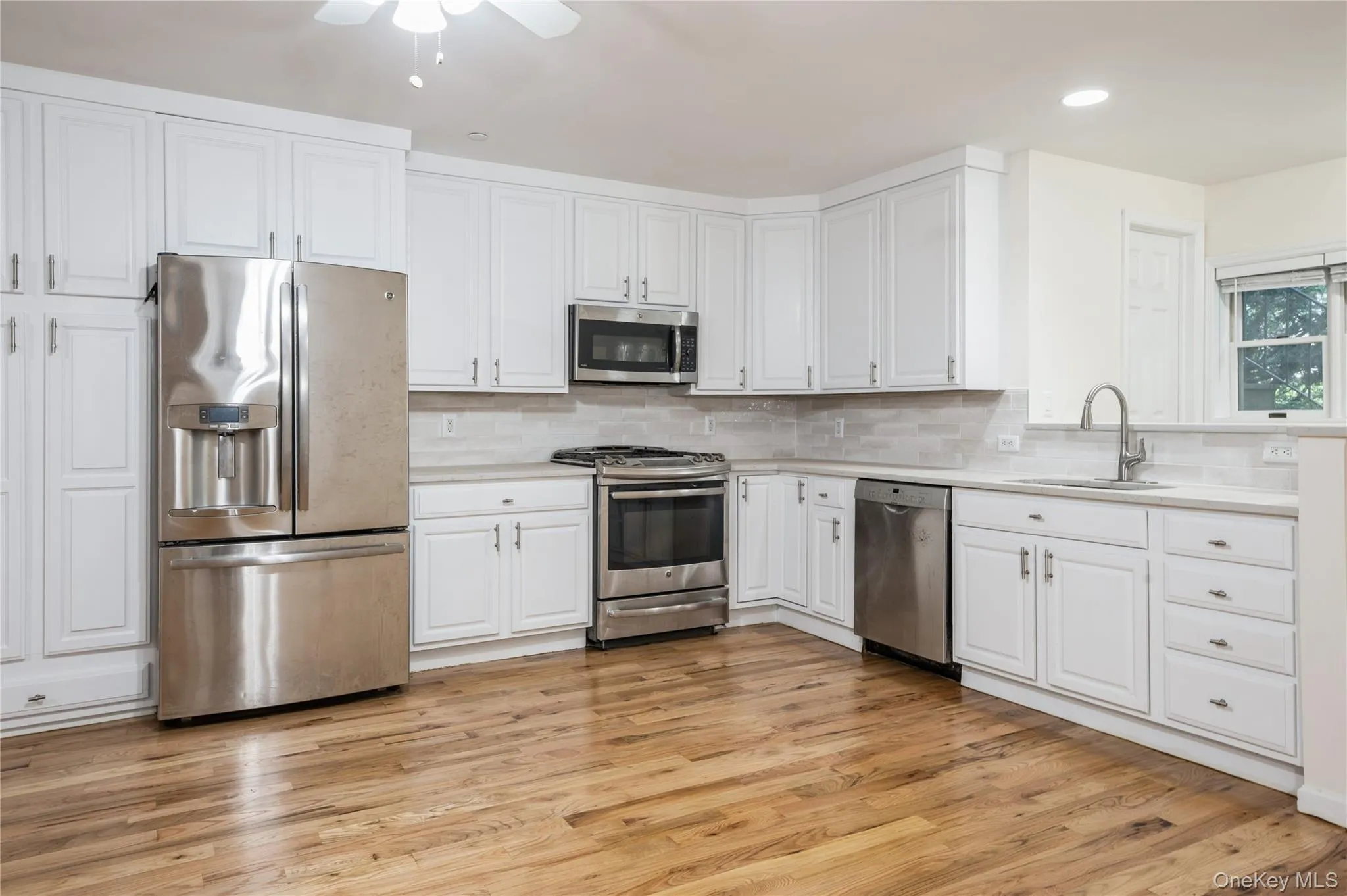 Another view of the modern, fully equipped open kitchen, with quartz counter tops, generous cabinet space and beautiful back splash. Another view of the modern, fully equipped open kitchen, with quartz counter tops, generous cabinet space and beautiful back splash.