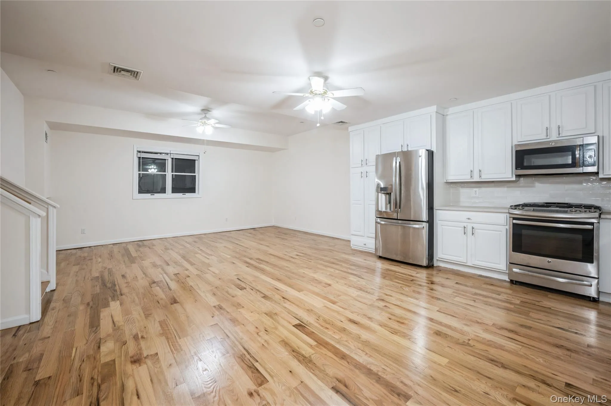 Spacious, open kitchen with large dining area, stainless steel refrigerator, microwave and gas stove; shining hardwood floor, ceiling fan. Spacious, open kitchen with large dining area, stainless steel refrigerator, microwave and gas stove; shining hardwood floor, ceiling fan.