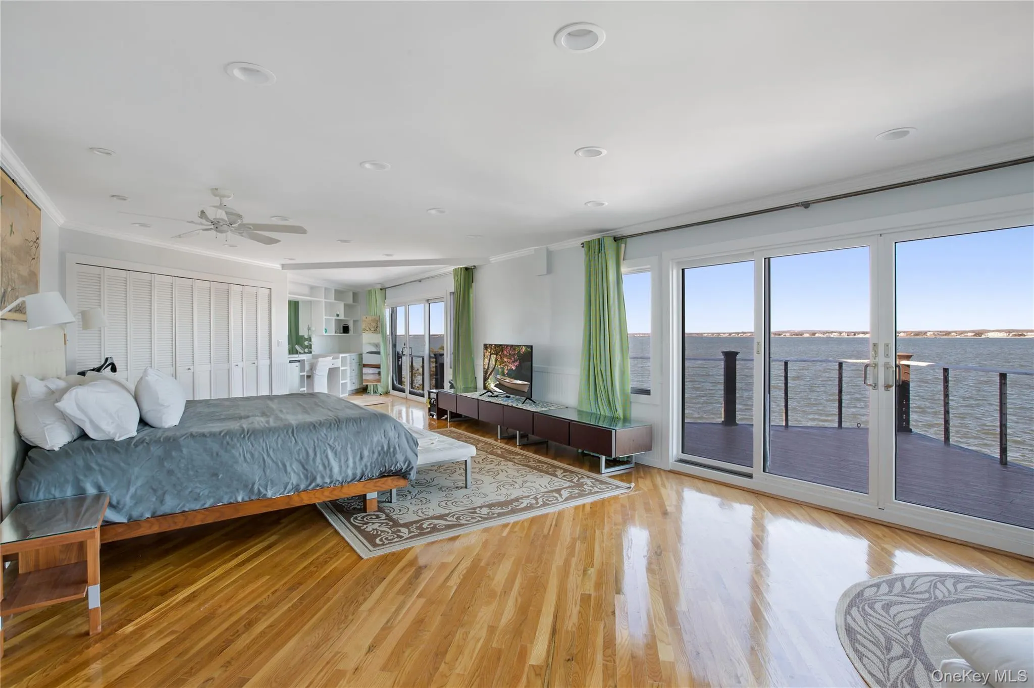 Bedroom featuring access to exterior, crown molding, a closet, light wood-style flooring, and a ceiling fan Bedroom featuring access to exterior, crown molding, a closet, light wood-style flooring, and a ceiling fan