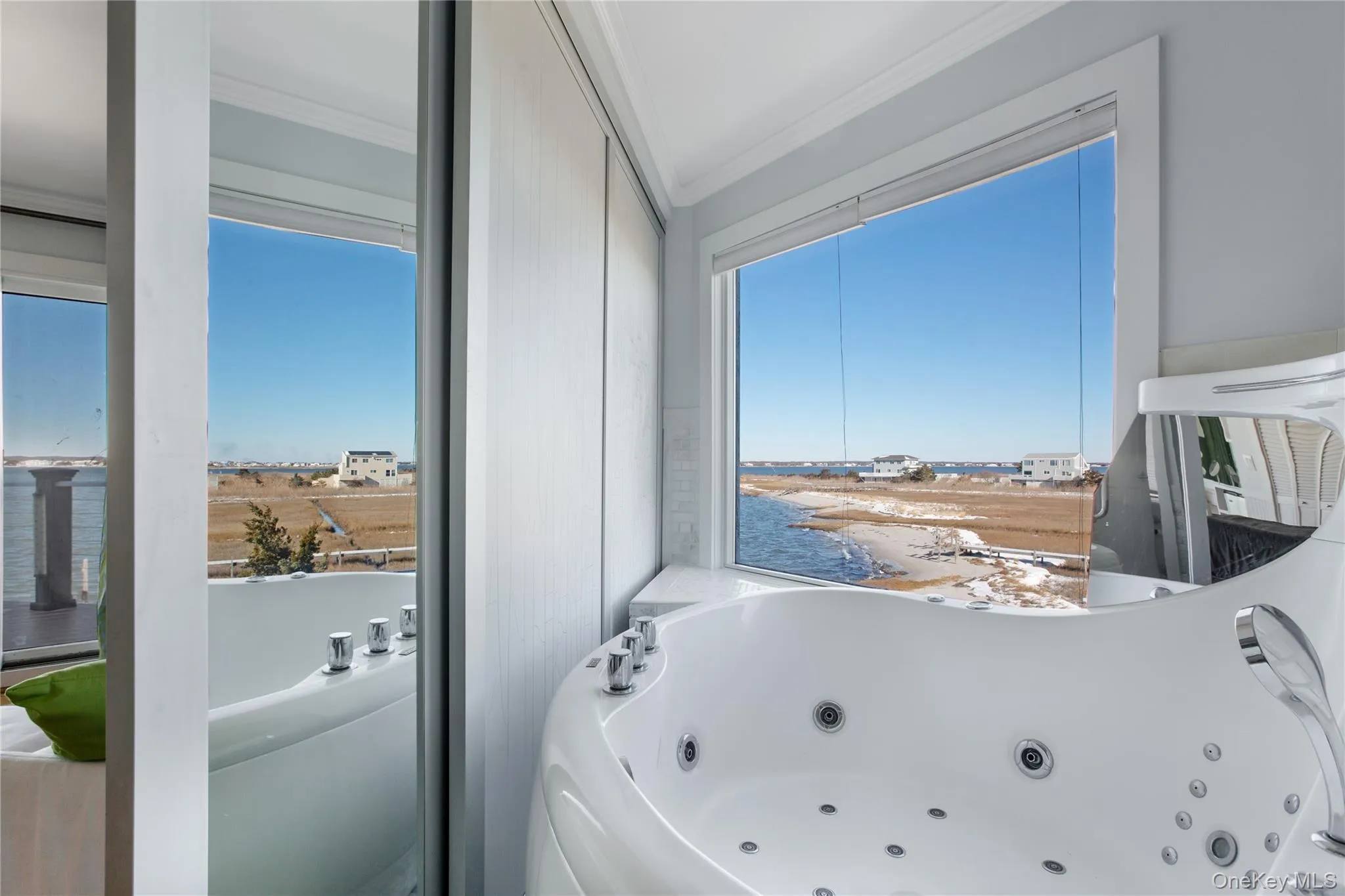 Full bathroom with a water view, a whirlpool tub, and crown molding Full bathroom with a water view, a whirlpool tub, and crown molding