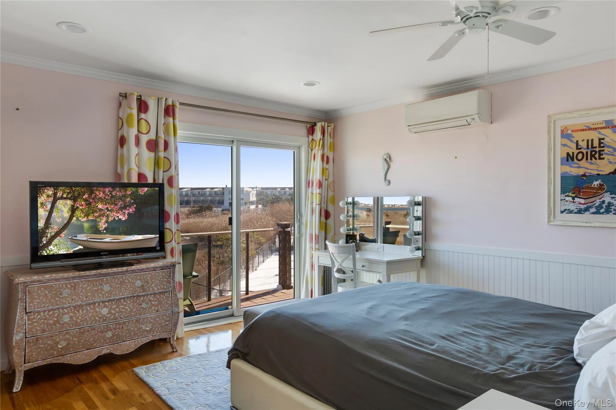 Bedroom with ornamental molding, access to exterior, a wall mounted AC, wood finished floors, and a ceiling fan Bedroom with ornamental molding, access to exterior, a wall mounted AC, wood finished floors, and a ceiling fan