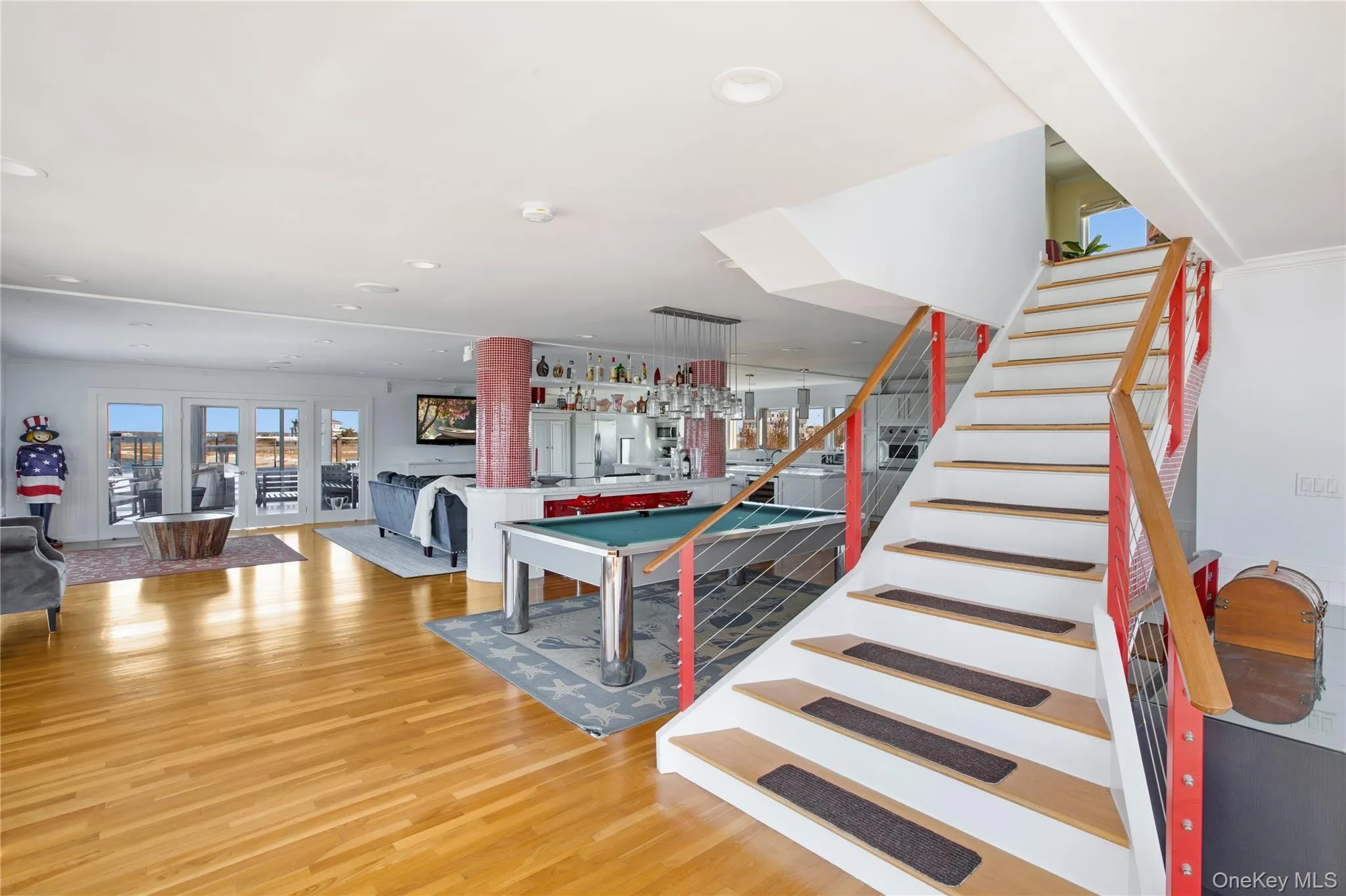 Stairway with wood finished floors, billiards table, and recessed lighting Stairway with wood finished floors, billiards table, and recessed lighting