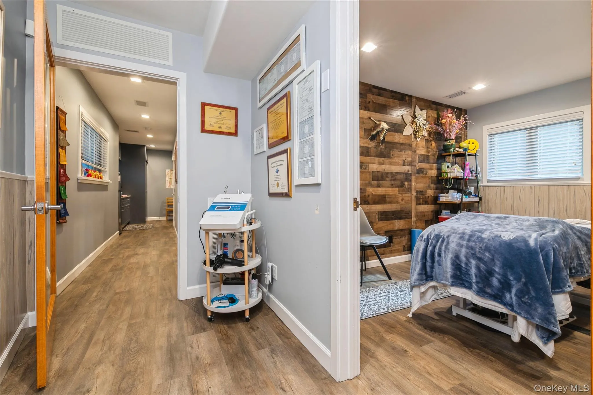 Treatment Room/ Office featuring dark wood finished floors, wood walls, and wainscoting, Storage Cabinet Treatment Room/ Office featuring dark wood finished floors, wood walls, and wainscoting, Storage Cabinet