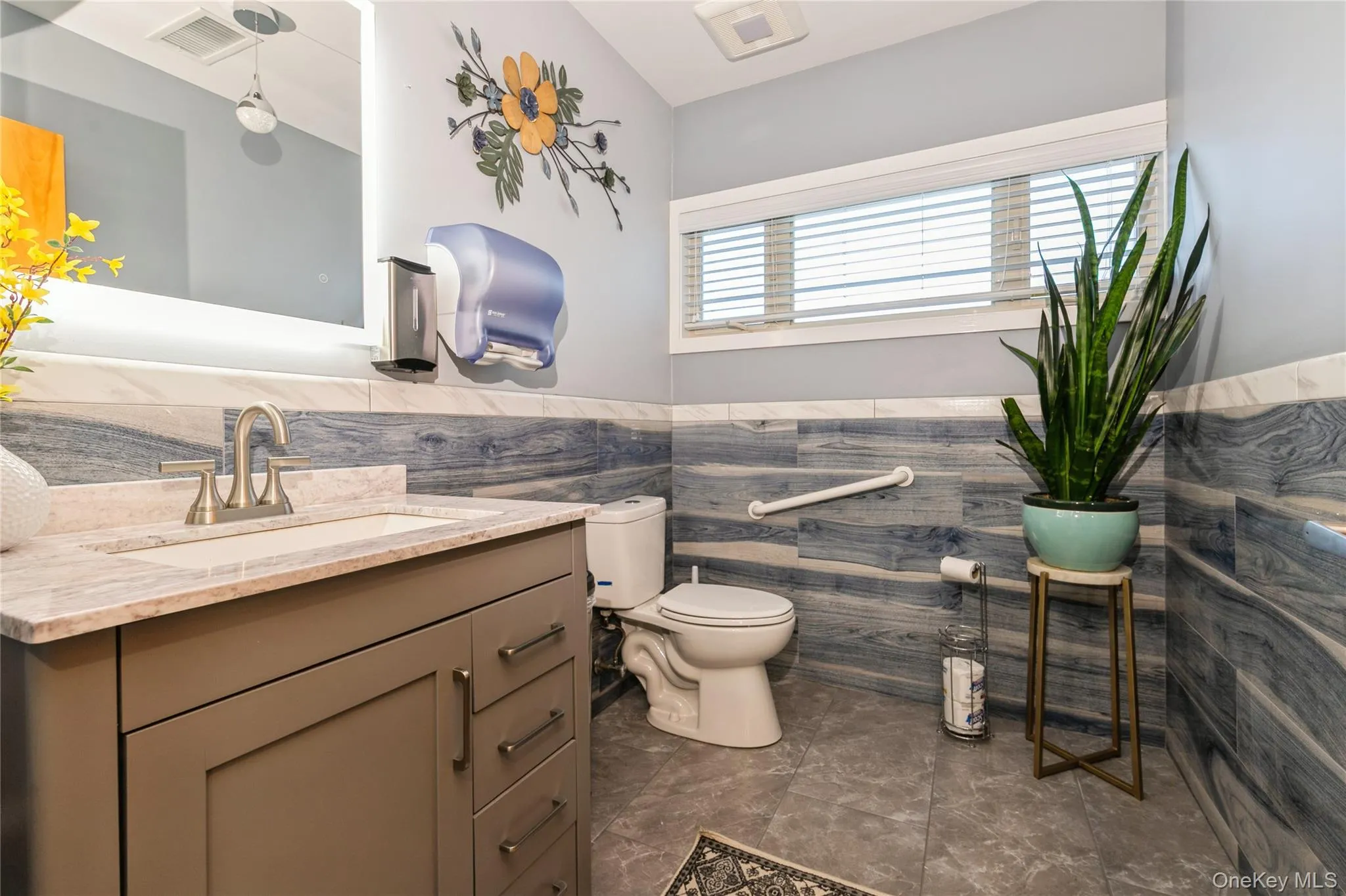 Handicapp Accessible Bathroom with vanity, wainscoting, and tile walls Handicapp Accessible Bathroom with vanity, wainscoting, and tile walls