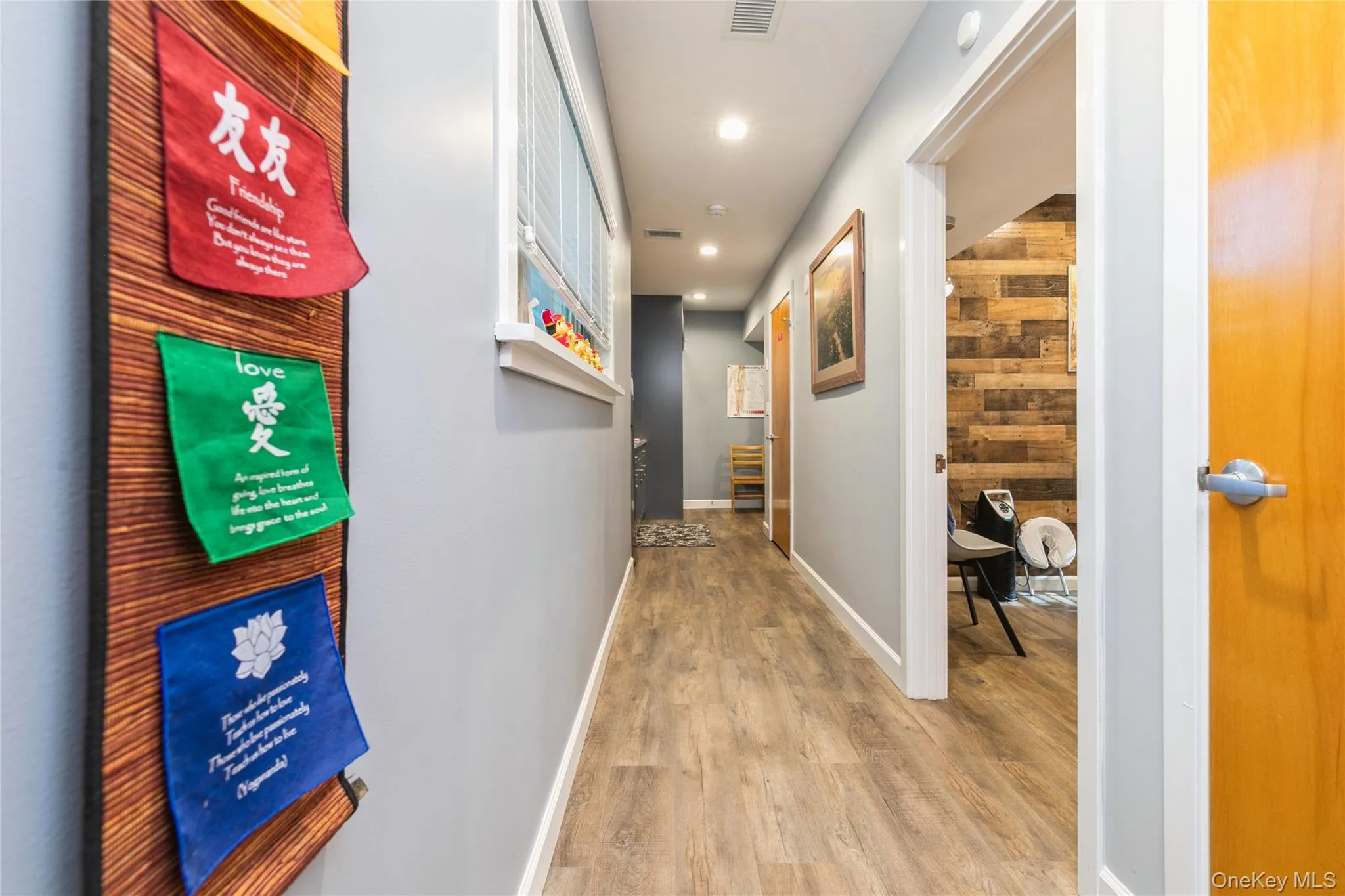 Treatment Room/ Office featuring dark wood finished floors, wood walls, and wainscoting, Storage Cabinet Treatment Room/ Office featuring dark wood finished floors, wood walls, and wainscoting, Storage Cabinet