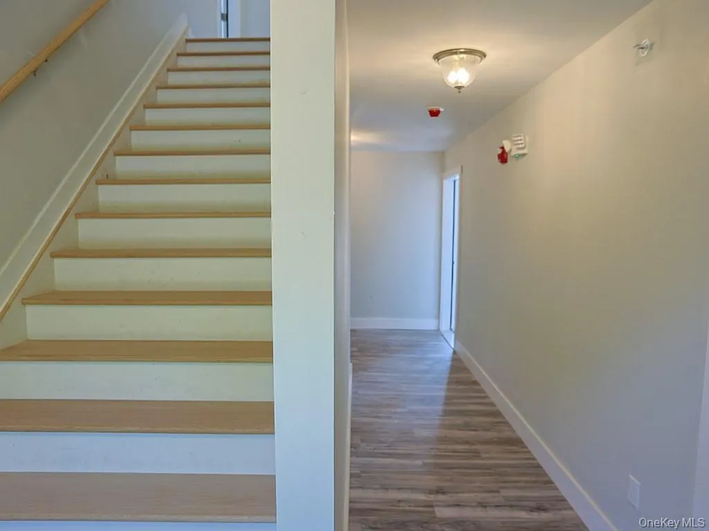 Staircase with baseboards and wood finished floors Staircase with baseboards and wood finished floors
