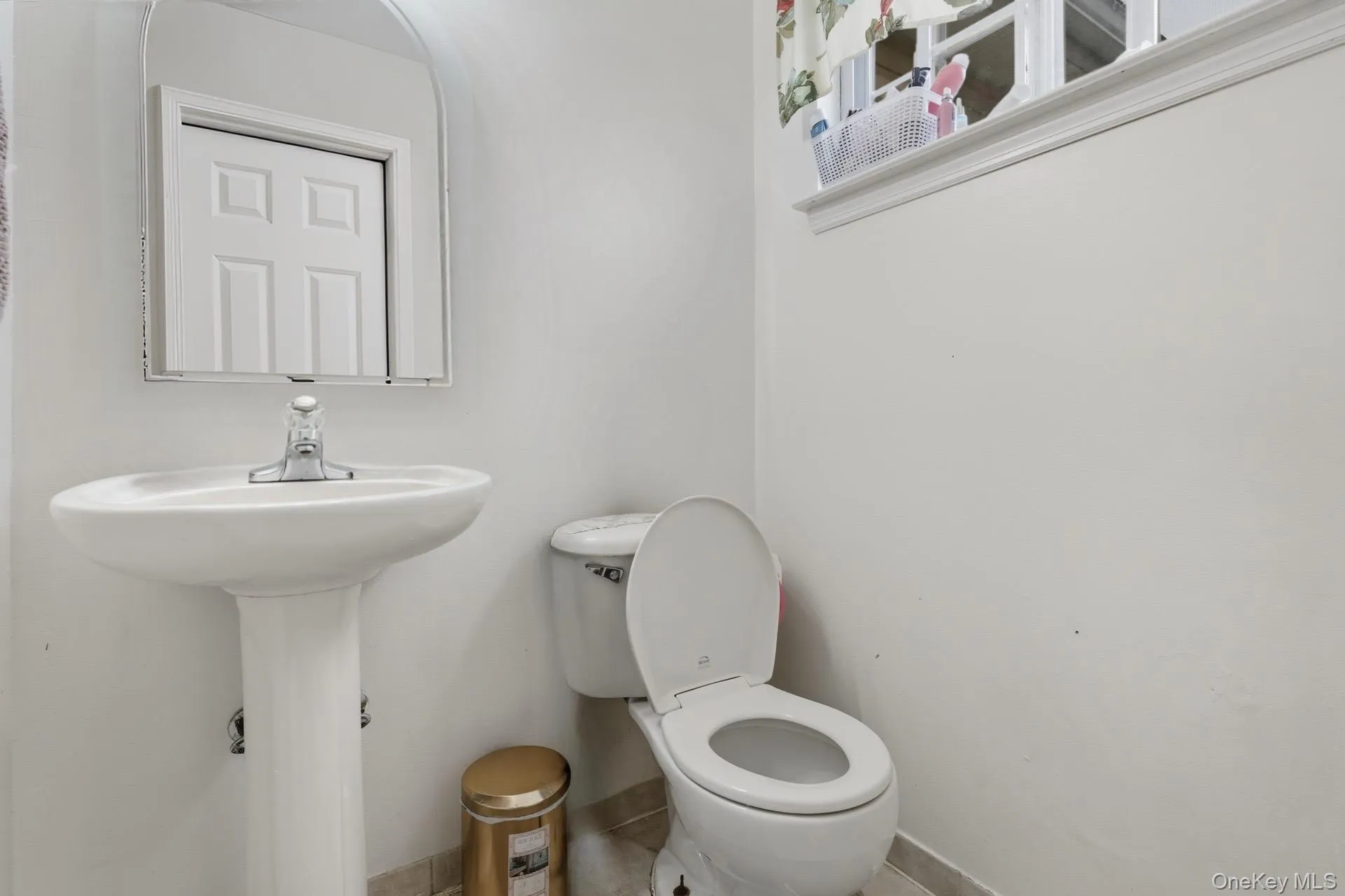 Half bathroom with toilet and baseboards Half bathroom with toilet and baseboards