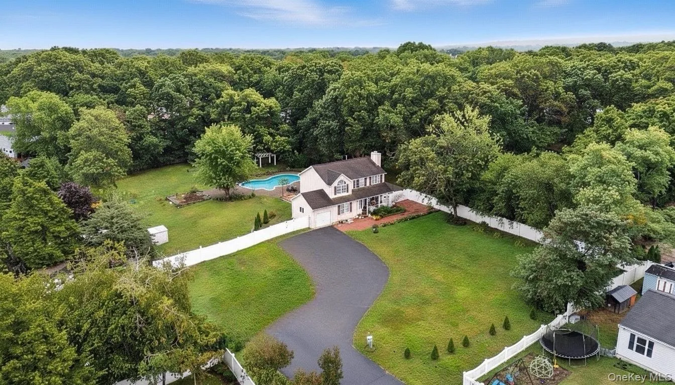 View from above of property with a heavily wooded area View from above of property with a heavily wooded area