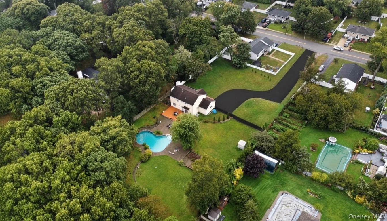 Aerial view of property and surrounding area with a pool Aerial view of property and surrounding area with a pool