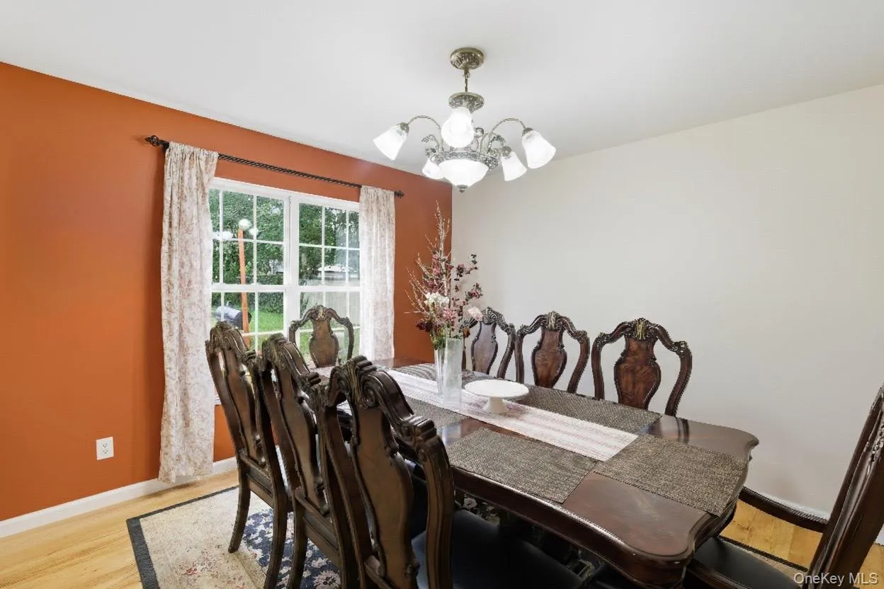 Dining room with a chandelier and light wood-type flooring Dining room with a chandelier and light wood-type flooring