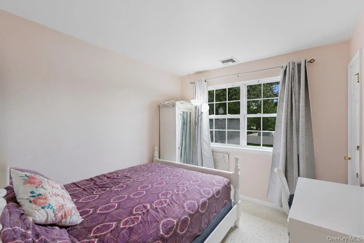 Carpeted bedroom featuring baseboards Carpeted bedroom featuring baseboards