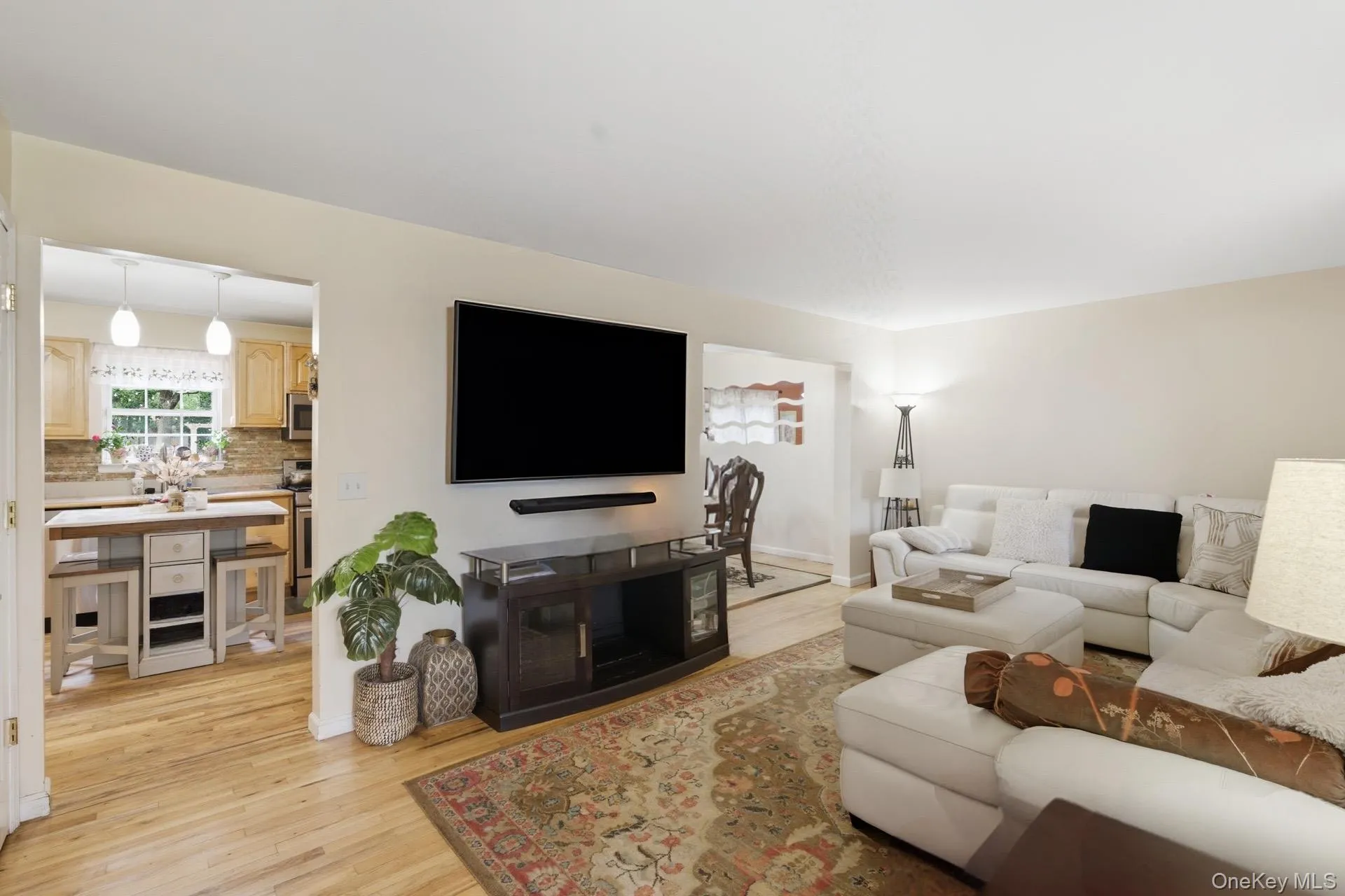 Living area featuring light wood-style floors and baseboards Living area featuring light wood-style floors and baseboards
