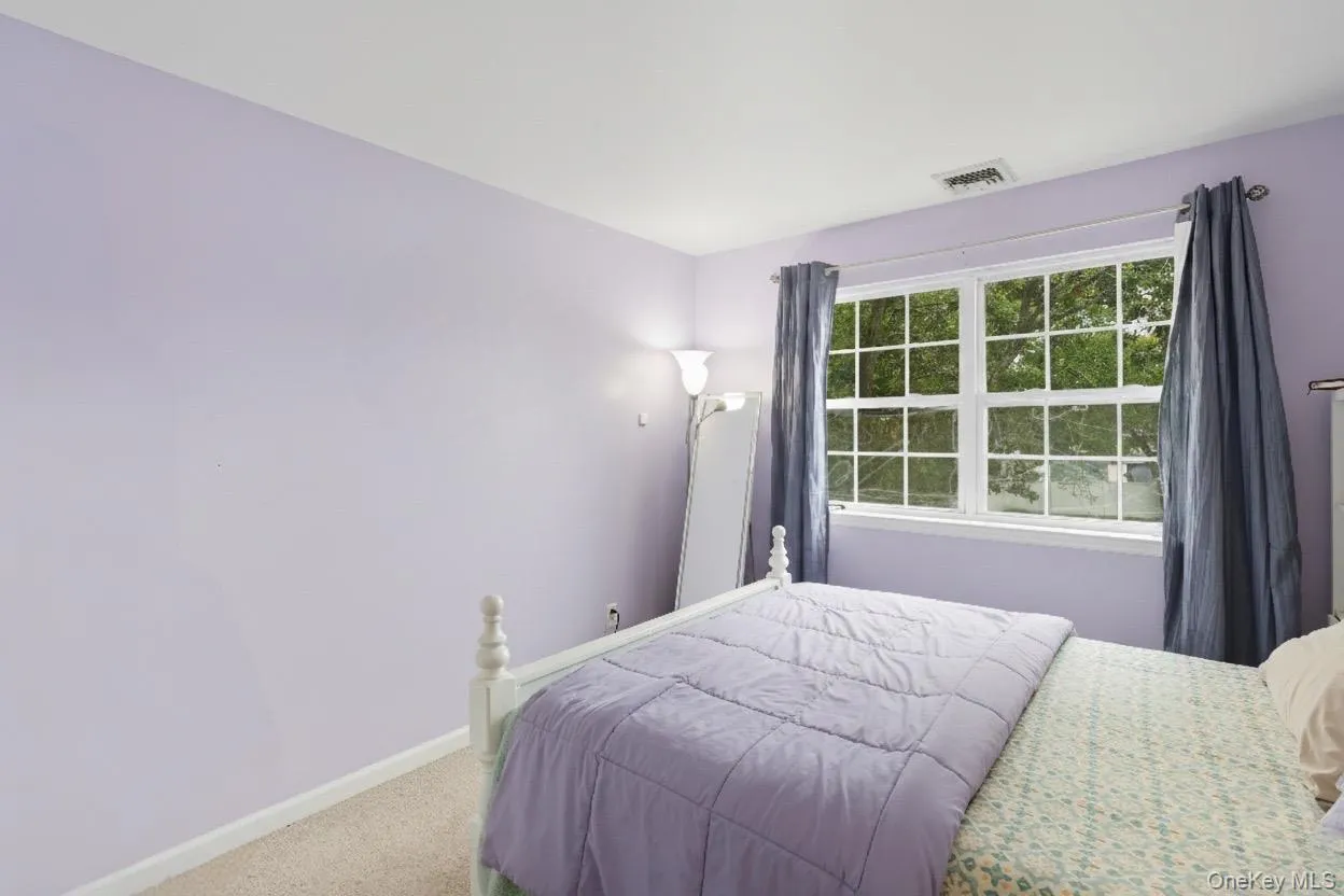 Carpeted bedroom with baseboards Carpeted bedroom with baseboards