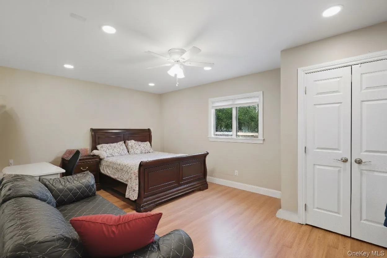 Bedroom featuring light wood-style floors, recessed lighting, a ceiling fan, and a closet Bedroom featuring light wood-style floors, recessed lighting, a ceiling fan, and a closet