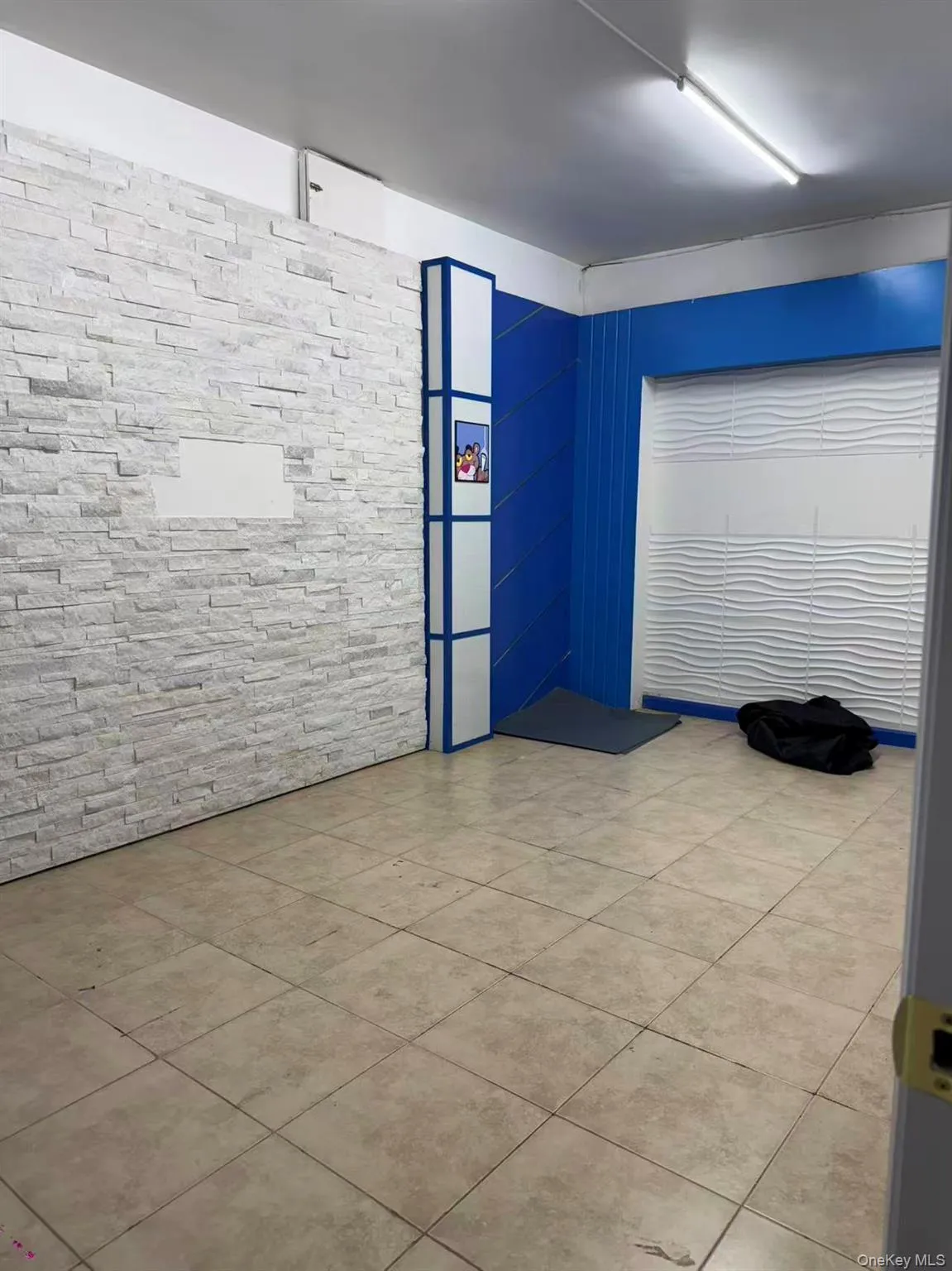 Unfurnished room with light tile patterned floors Unfurnished room with light tile patterned floors