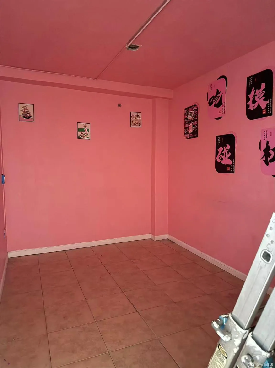 Tiled spare room featuring baseboards Tiled spare room featuring baseboards