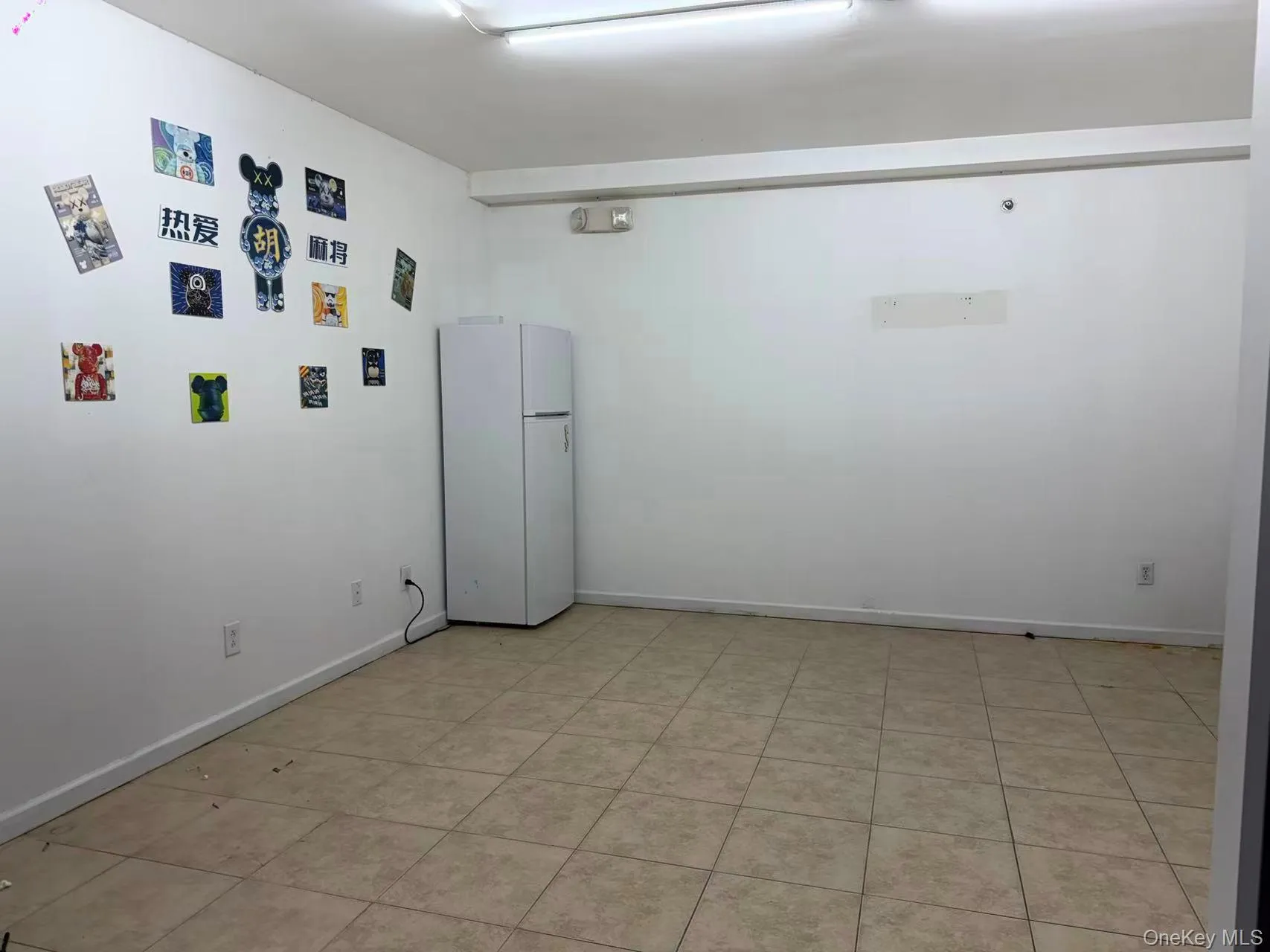 Spare room featuring baseboards and light tile patterned floors Spare room featuring baseboards and light tile patterned floors