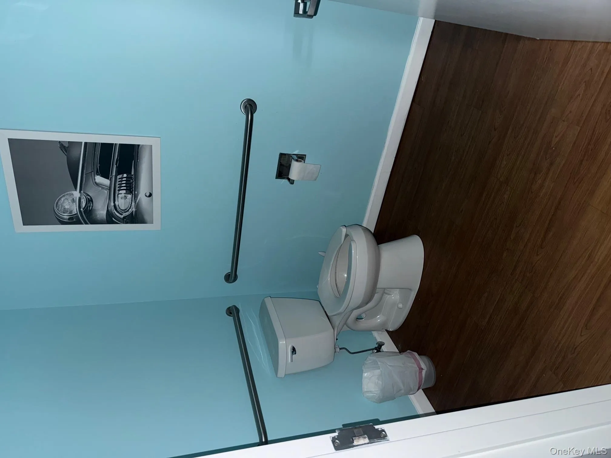 Half bathroom featuring dark wood-style flooring Half bathroom featuring dark wood-style flooring