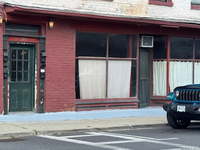 Property entrance with 2 large windows one on each side. Property entrance with 2 large windows one on each side.