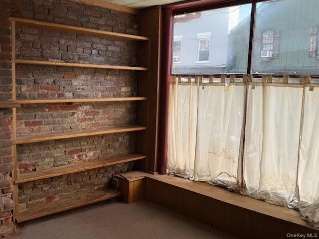 Built-in shelving by one of the front windows. Built-in shelving by one of the front windows.