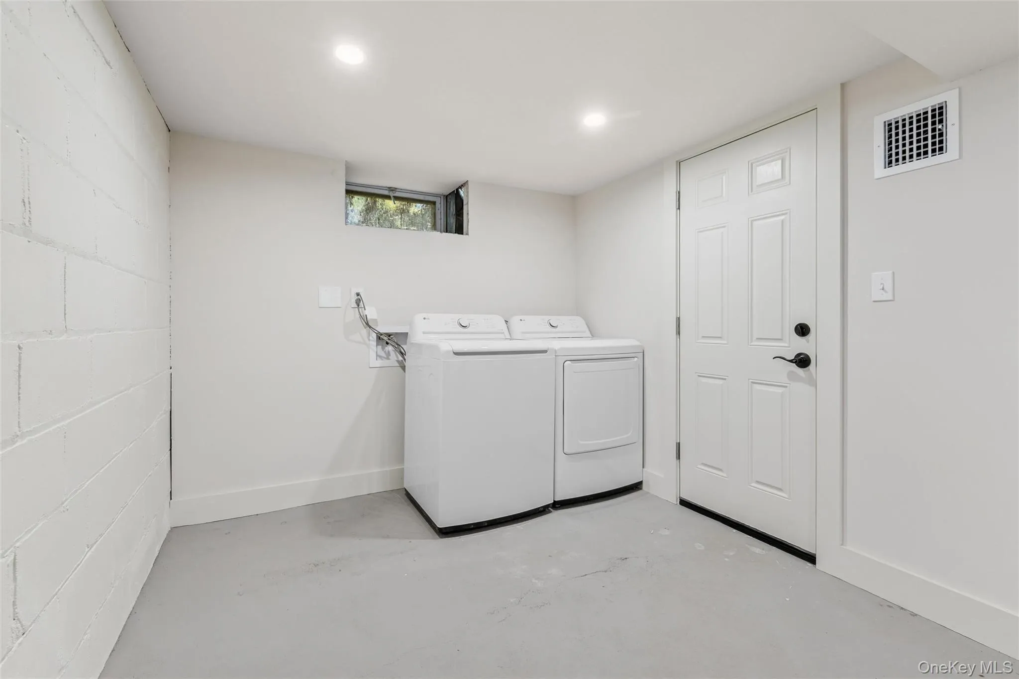 Washroom featuring washer and clothes dryer and baseboards Washroom featuring washer and clothes dryer and baseboards