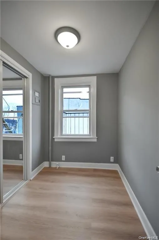 Unfurnished bedroom with light wood-type flooring and baseboards Unfurnished bedroom with light wood-type flooring and baseboards
