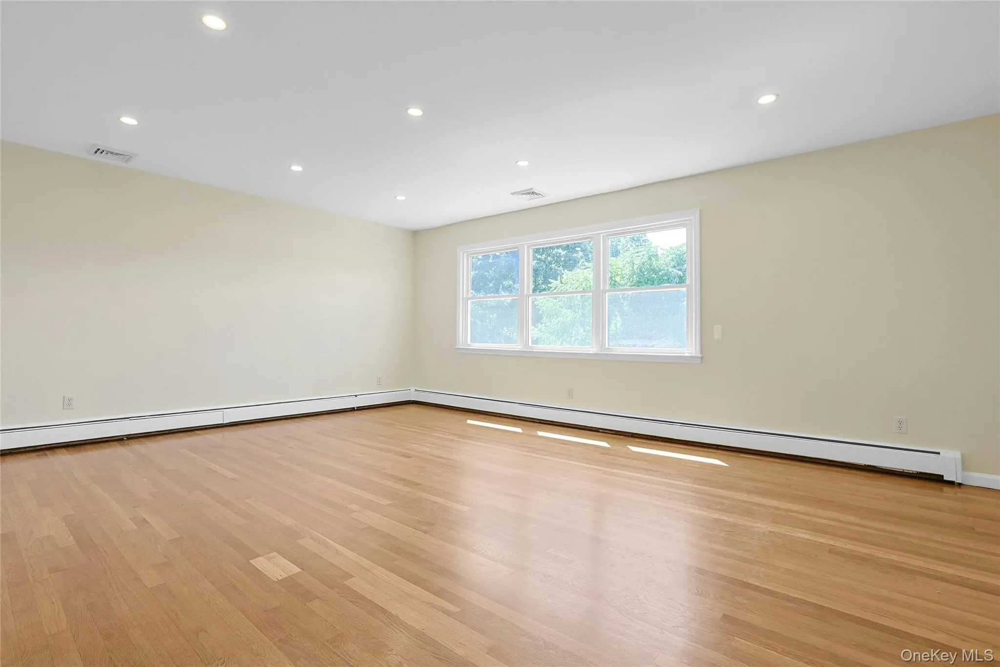Large Living room with hardwood floors and recessed lights Large Living room with hardwood floors and recessed lights