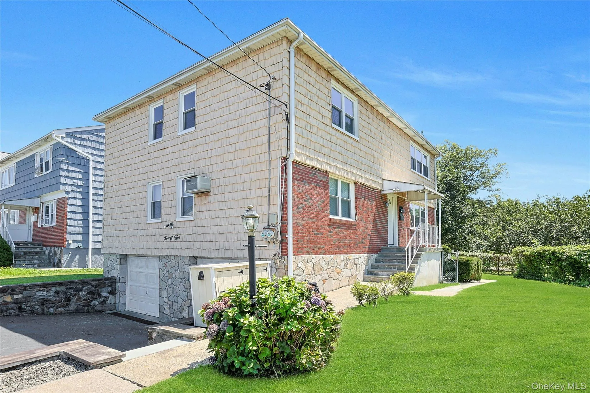 View of property exterior featuring a yard and an attached garage View of property exterior featuring a yard and an attached garage