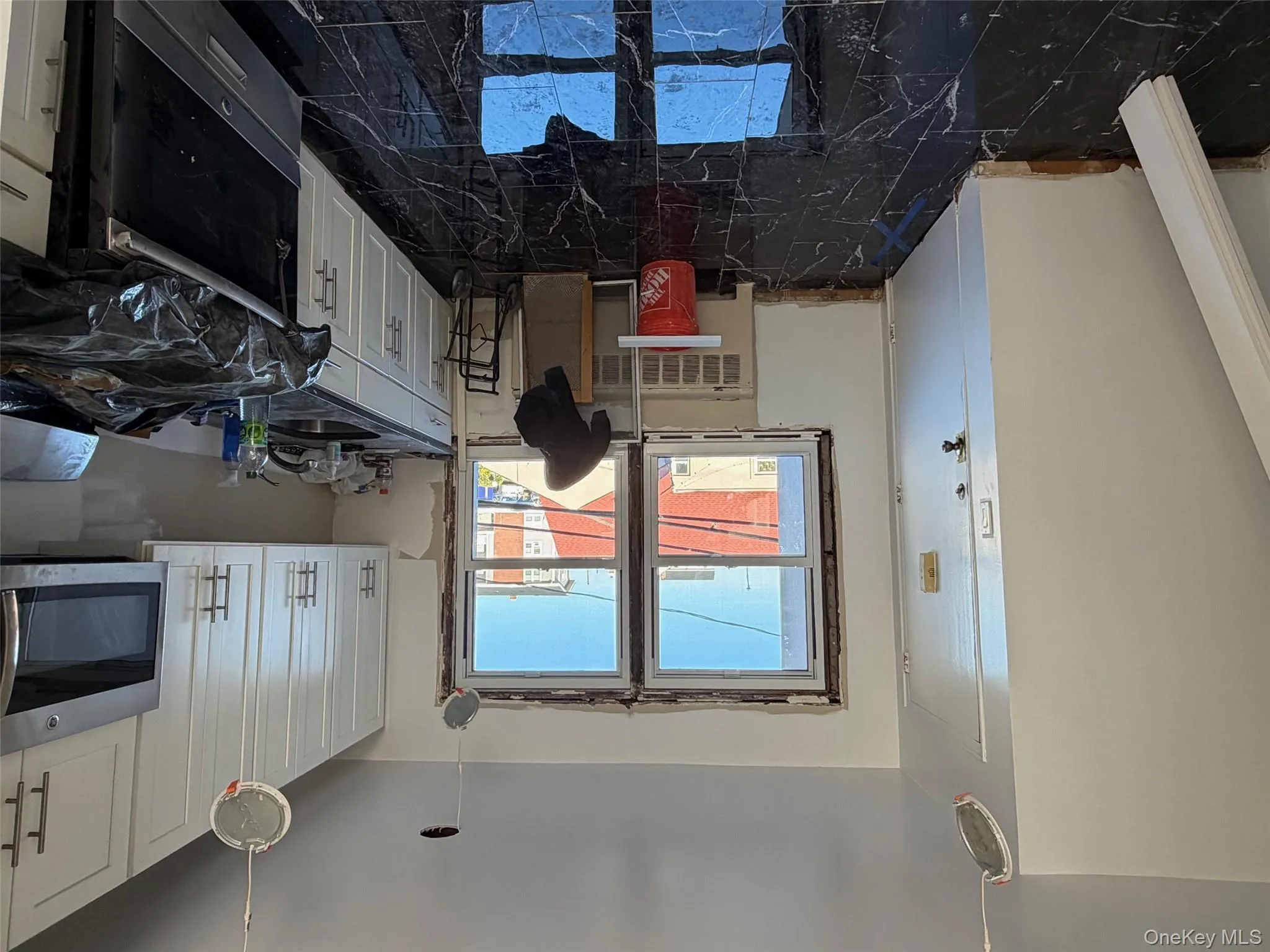 Kitchen with range, white cabinets, and dark marble finish flooring Kitchen with range, white cabinets, and dark marble finish flooring