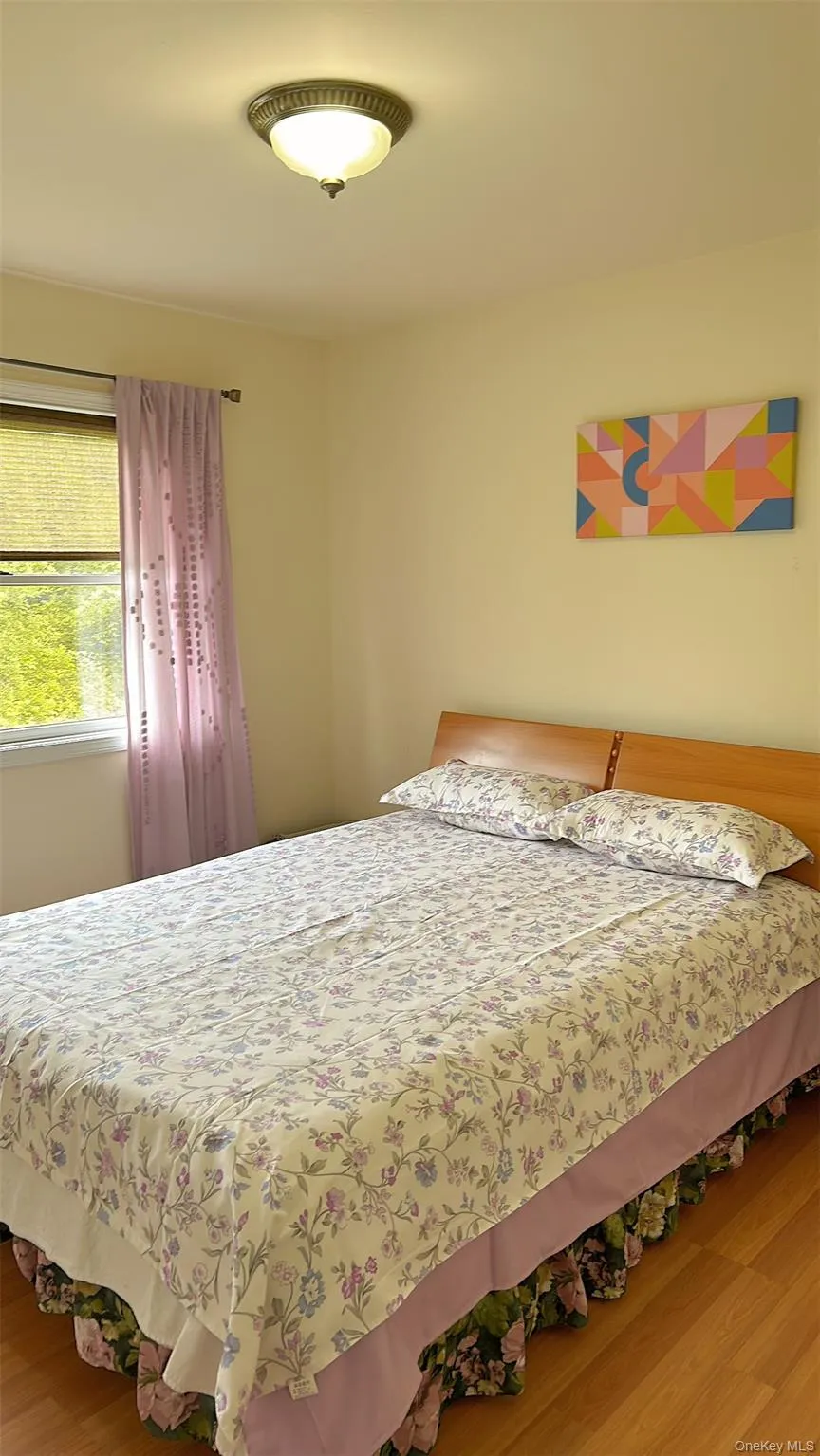 Bedroom featuring wood finished floors Bedroom featuring wood finished floors