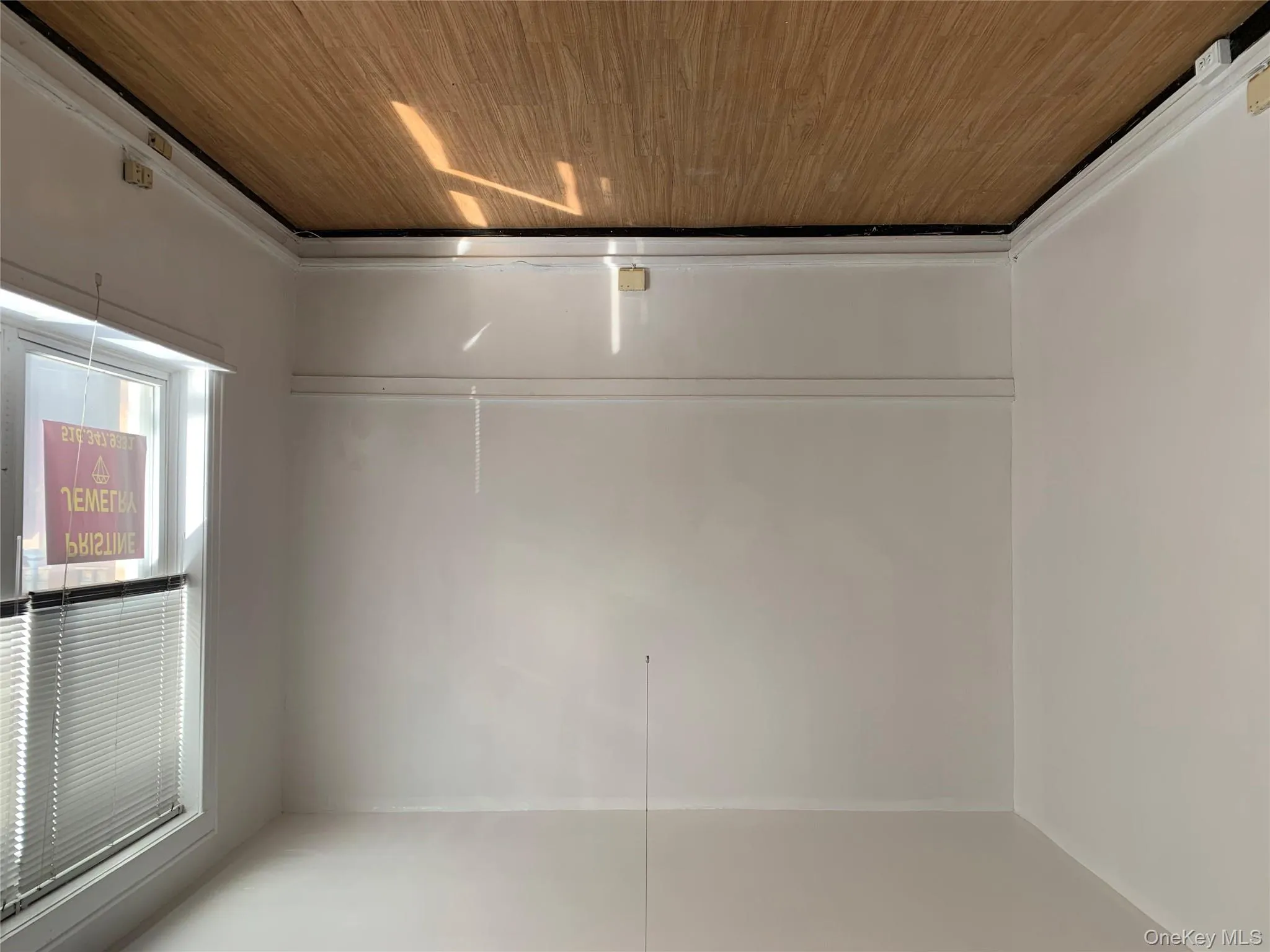 Unfurnished room with wood finished floors and baseboards Unfurnished room with wood finished floors and baseboards