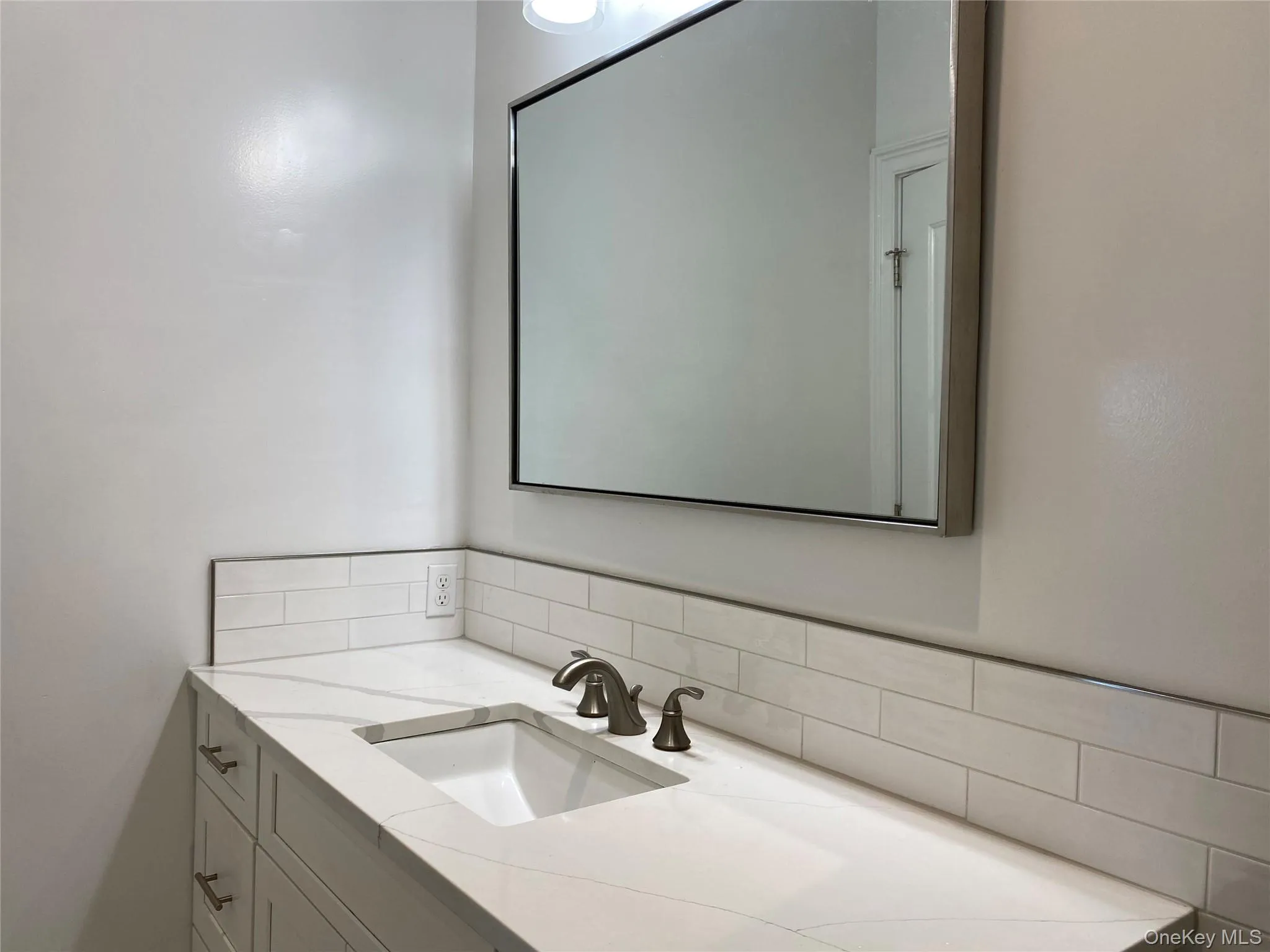 Bathroom with vanity and tasteful backsplash Bathroom with vanity and tasteful backsplash