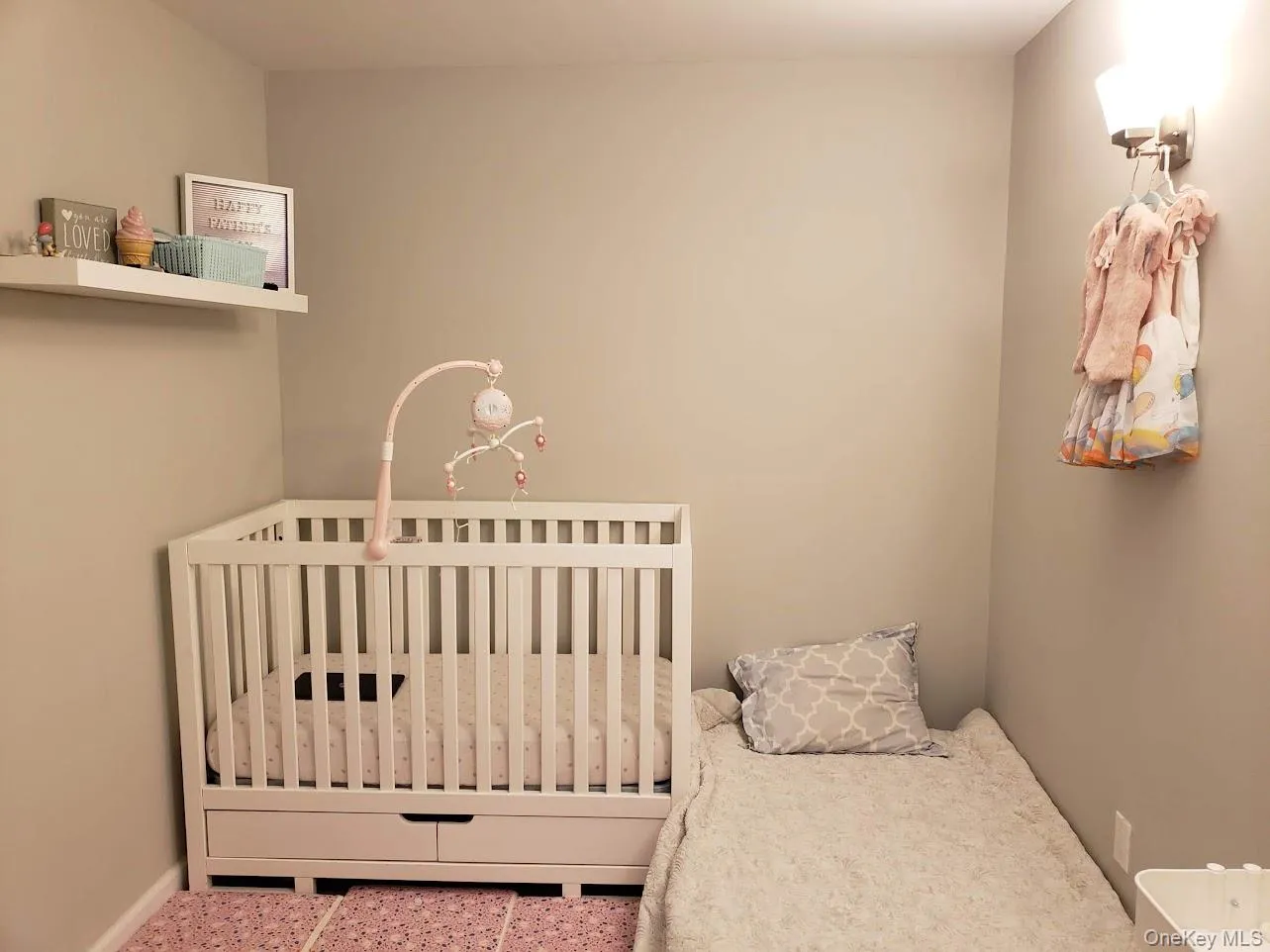 Bedroom featuring a nursery area and baseboards Bedroom featuring a nursery area and baseboards
