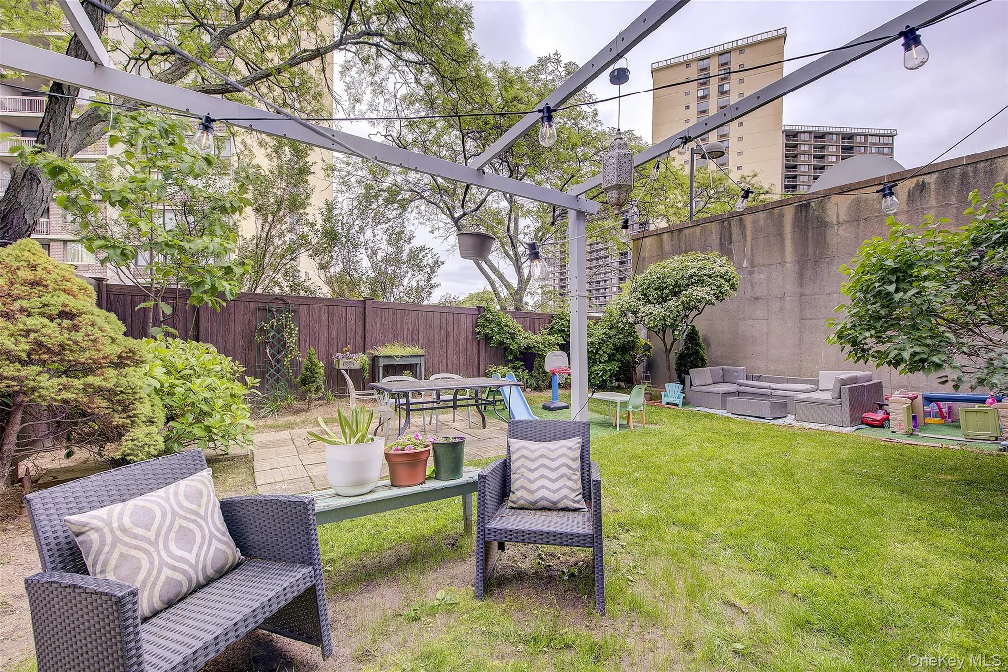 Fenced backyard featuring a patio, an outdoor living space, and a pergola Fenced backyard featuring a patio, an outdoor living space, and a pergola