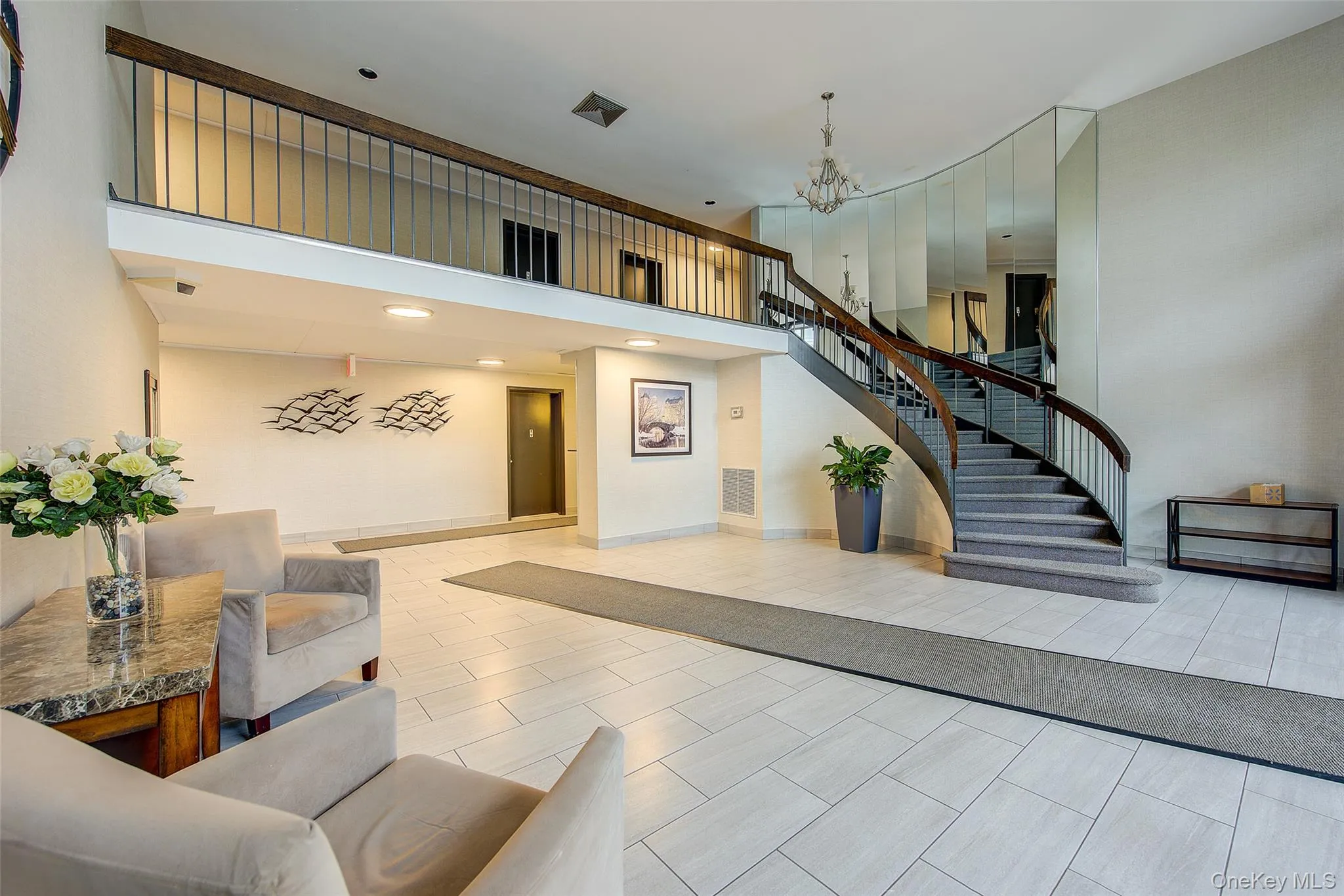 Building lobby with a high ceiling, stairs, and recessed lighting Building lobby with a high ceiling, stairs, and recessed lighting
