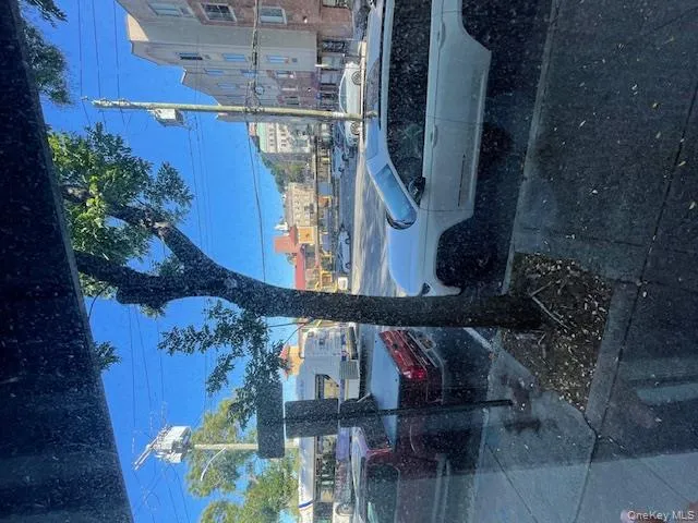 View of asphalt road featuring sidewalks and street lighting View of asphalt road featuring sidewalks and street lighting