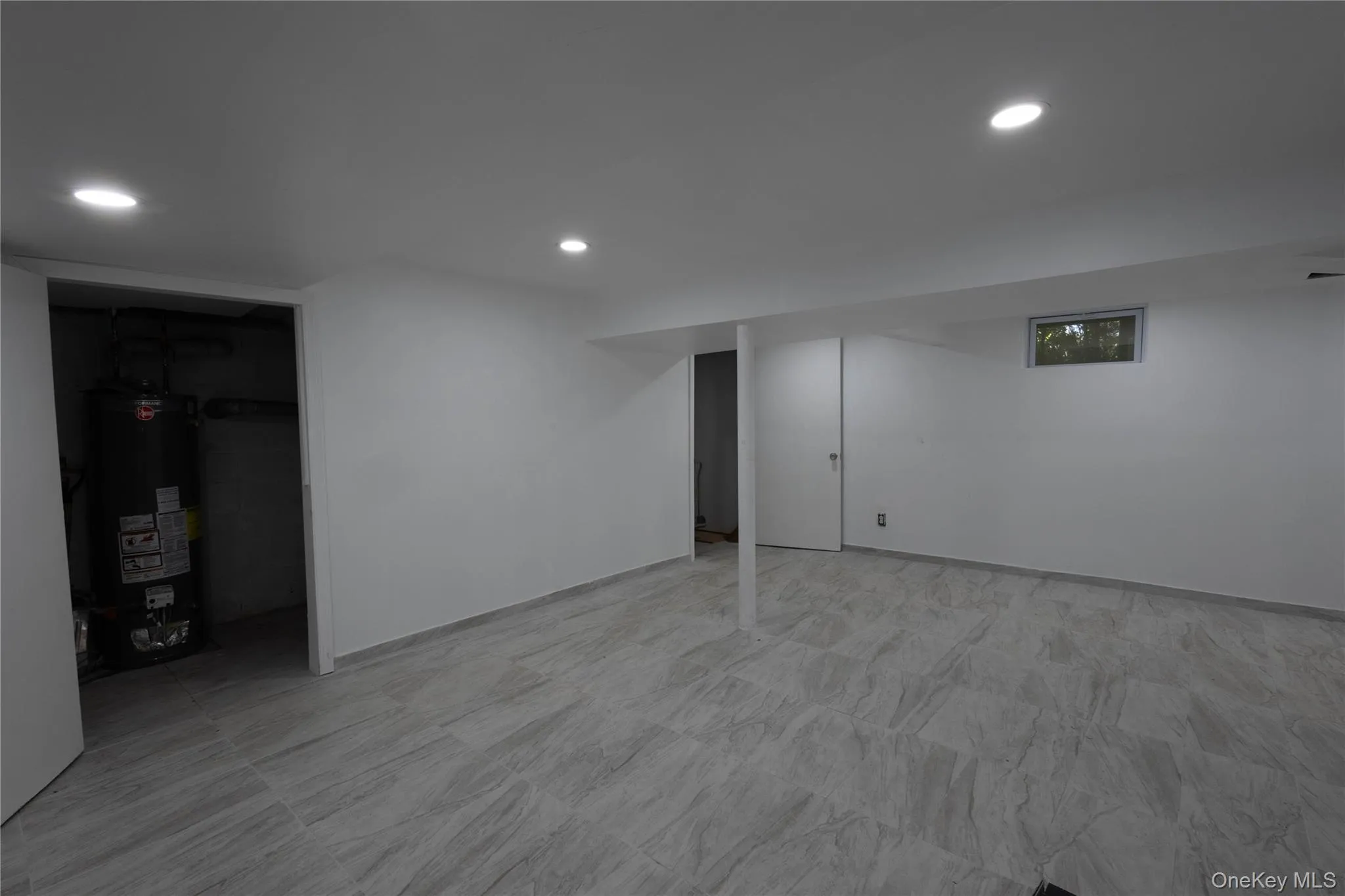 Finished basement with gas water heater, recessed lighting, and light floors Finished basement with gas water heater, recessed lighting, and light floors