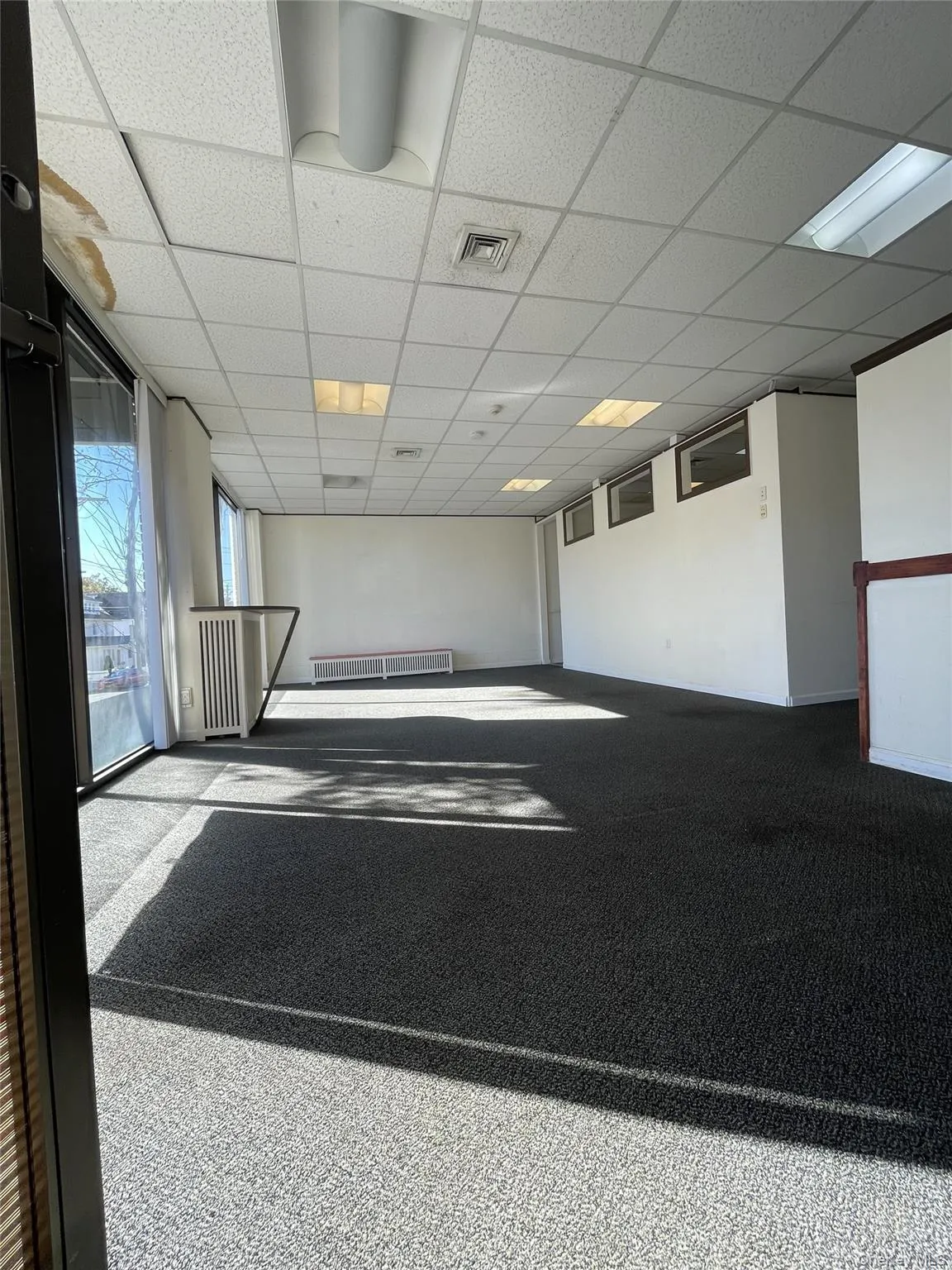 Carpeted spare room featuring a paneled ceiling Carpeted spare room featuring a paneled ceiling