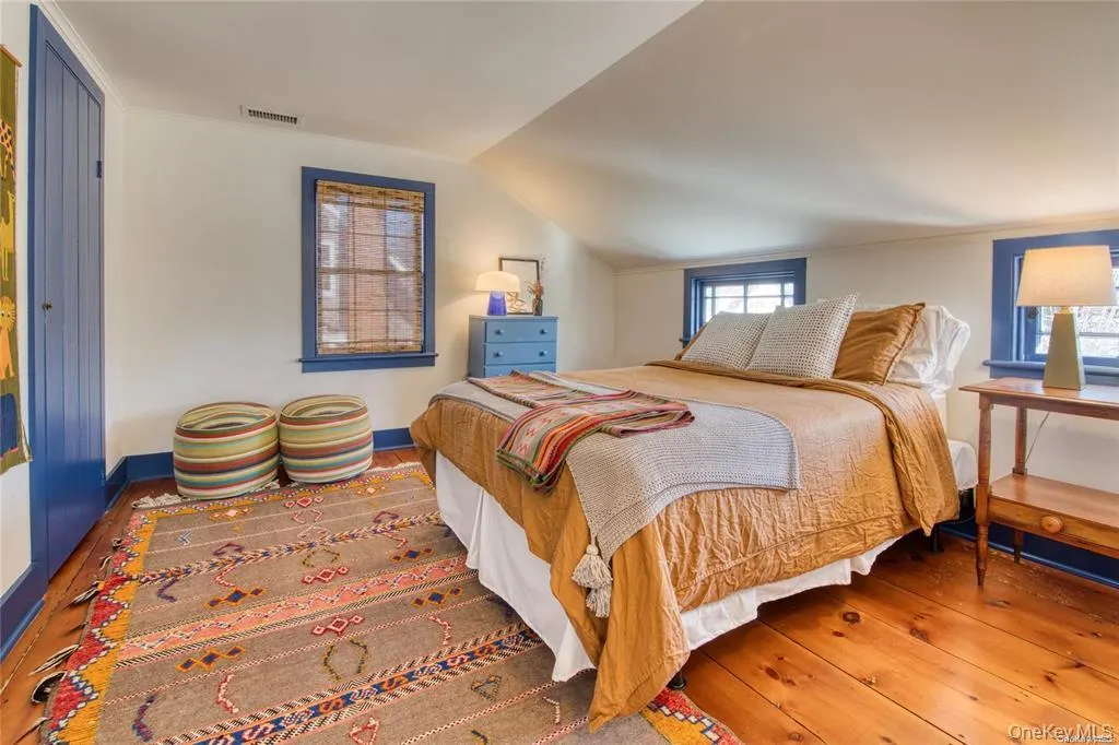 Bedroom with hardwood / wood-style flooring and vaulted ceiling Bedroom with hardwood / wood-style flooring and vaulted ceiling
