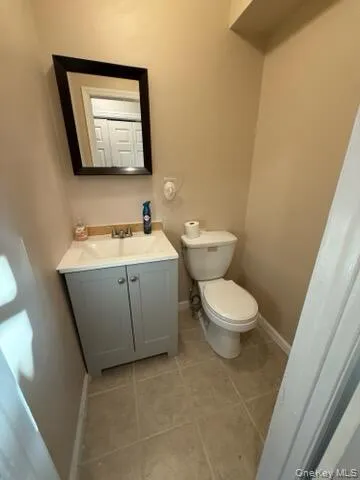 Bathroom featuring vanity and light tile patterned floors Bathroom featuring vanity and light tile patterned floors