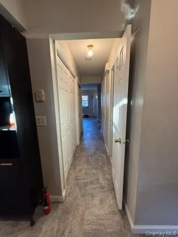 Hall featuring baseboards Hall featuring baseboards